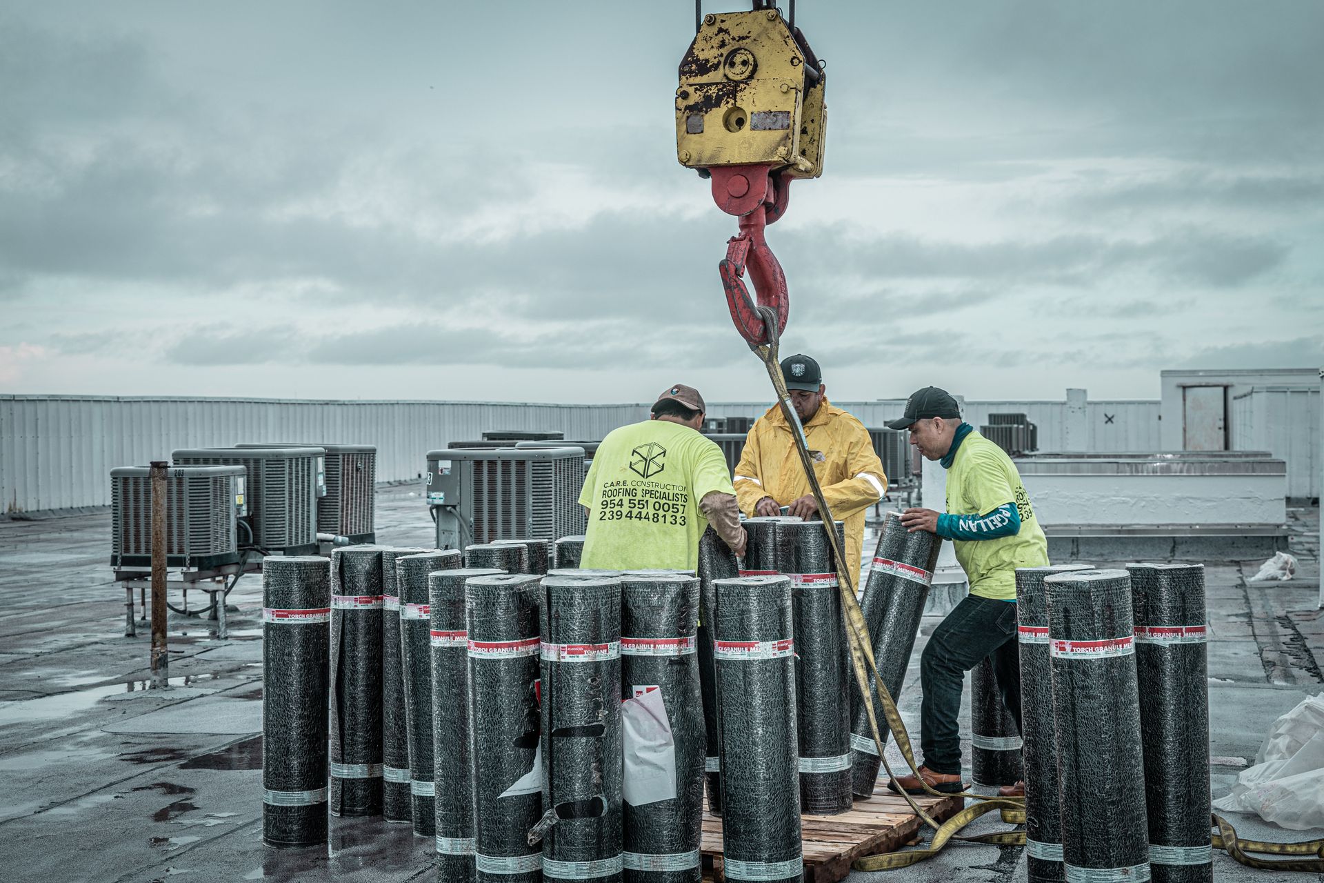 A group of construction workers are working on a roof.