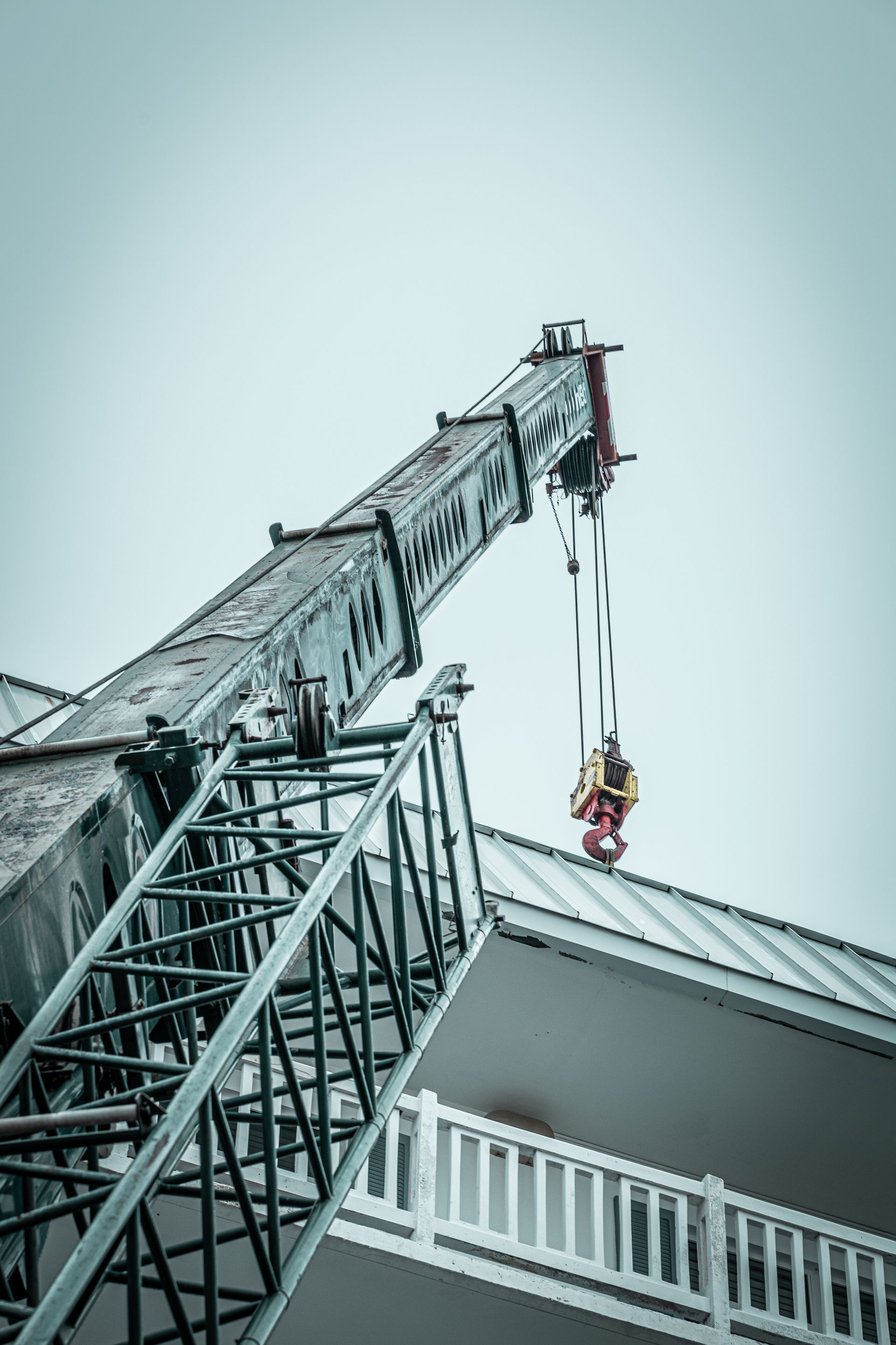 A large crane is sitting on top of a building.