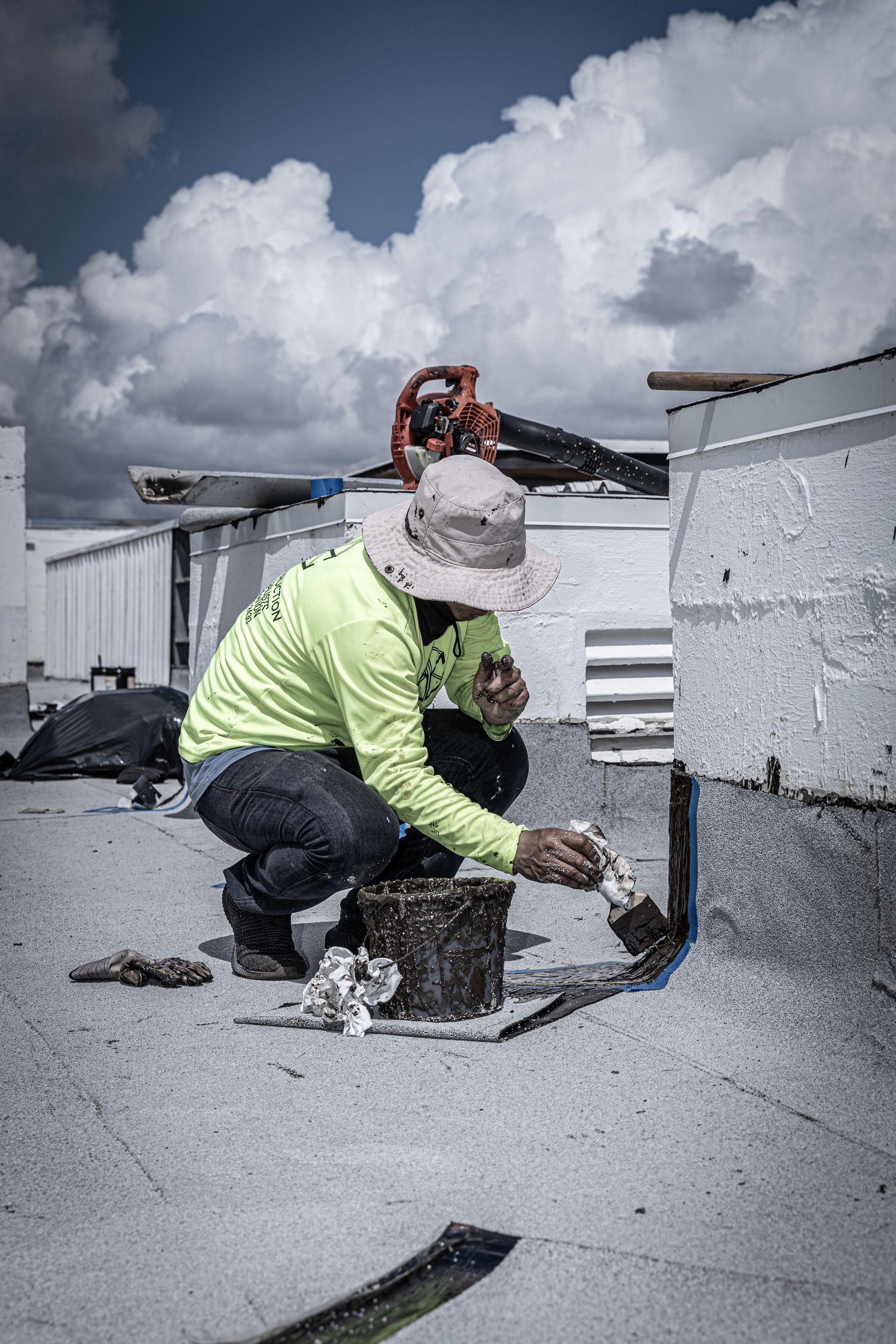 Two construction workers are working on a concrete floor