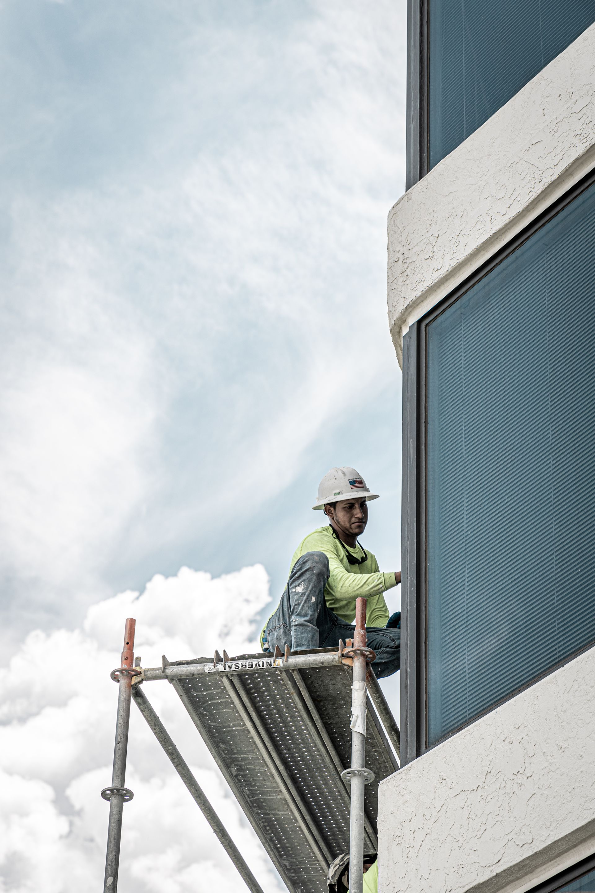 A group of people are working on the side of a building