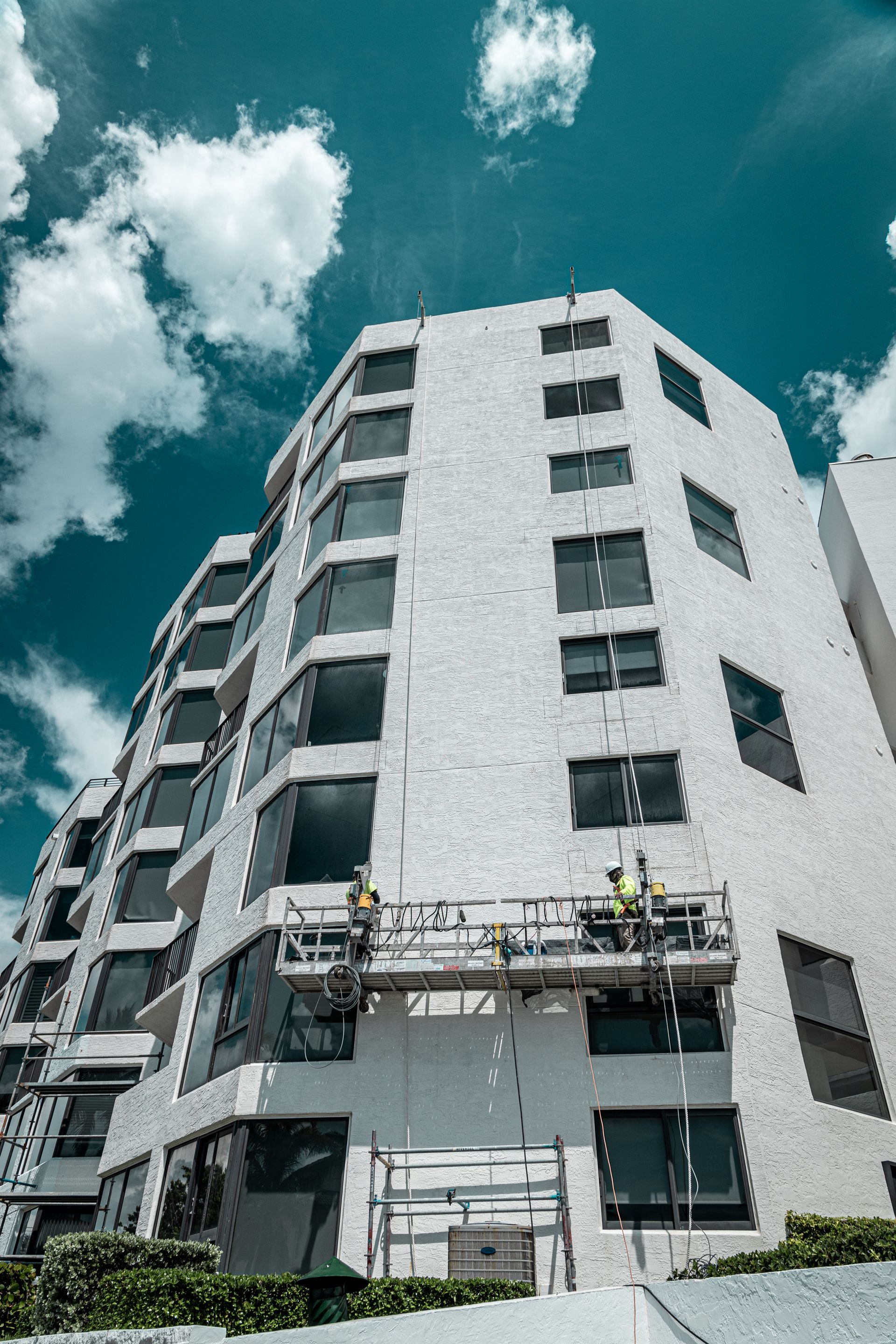 A group of people are working on the side of a building