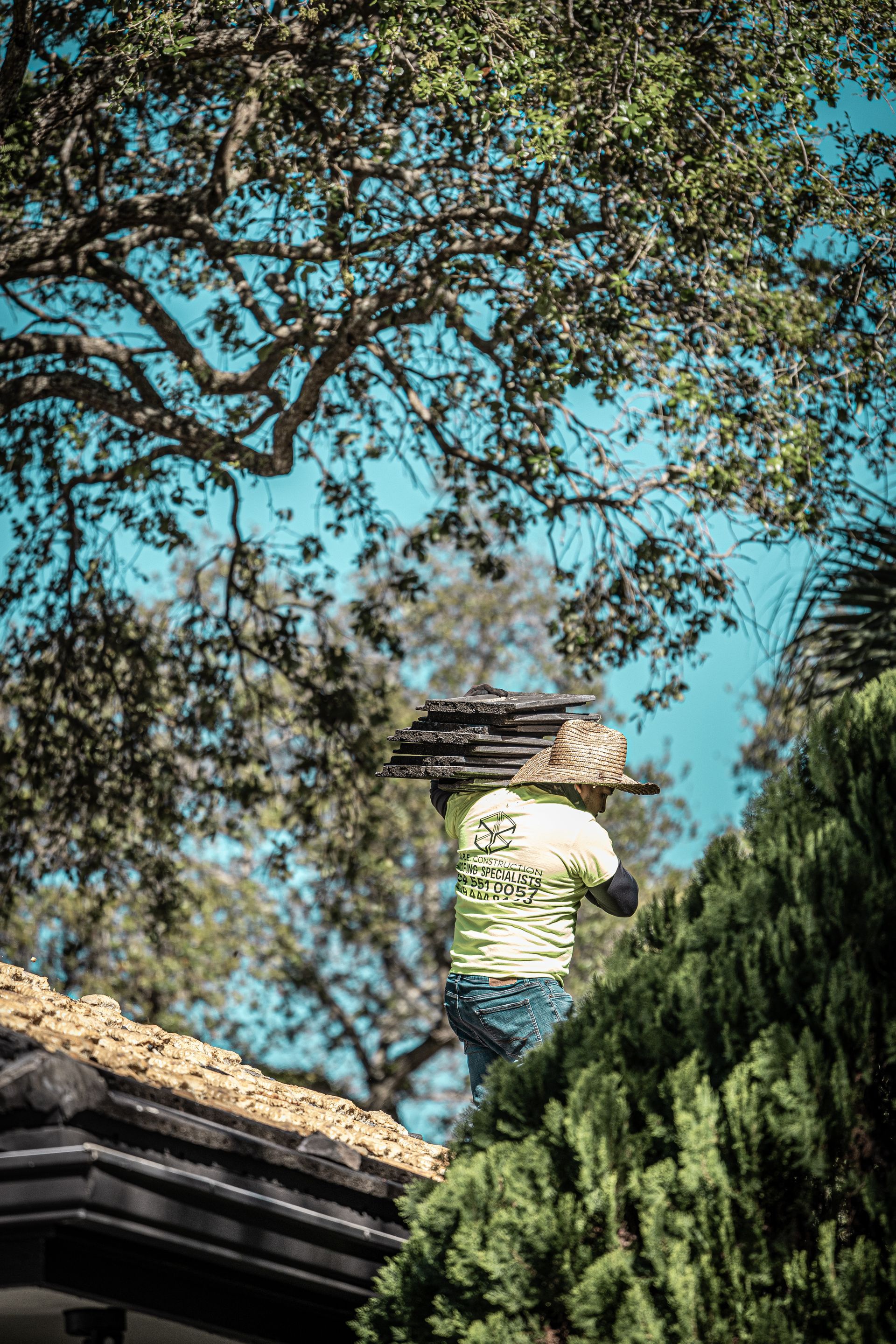 A man is working on the roof of a house.