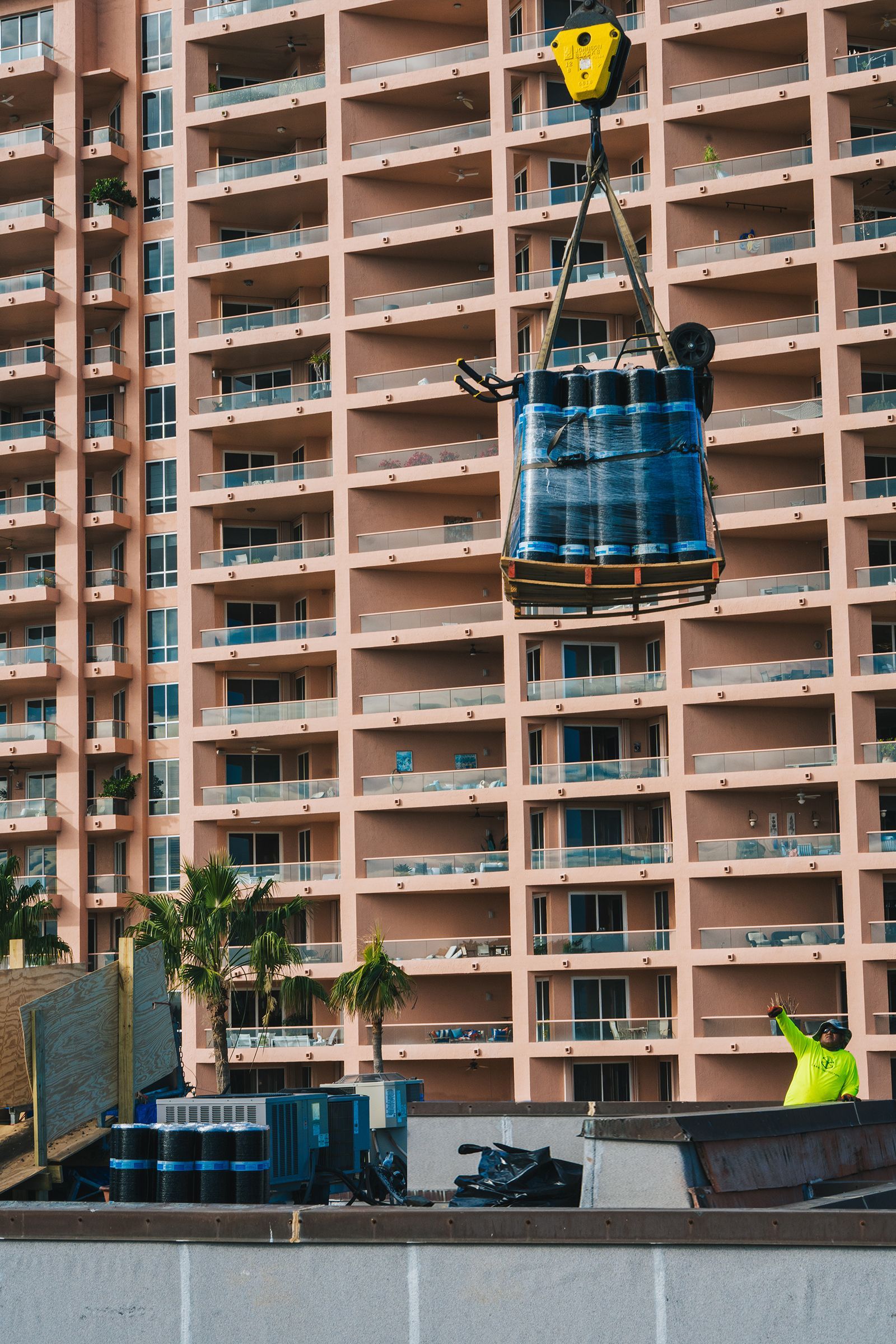 A group of people are working on the roof of a building.