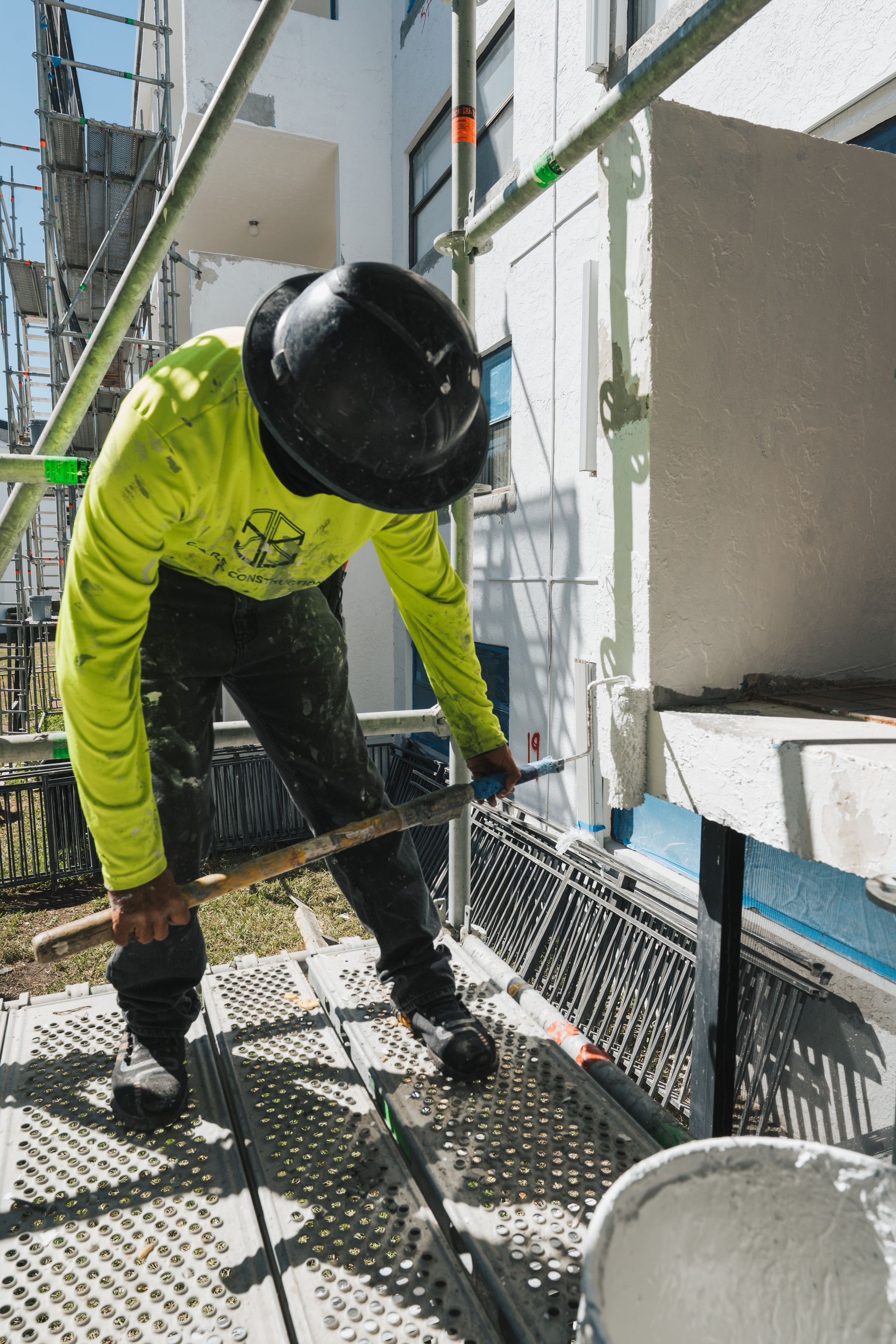 A group of people are working on the roof of a building.