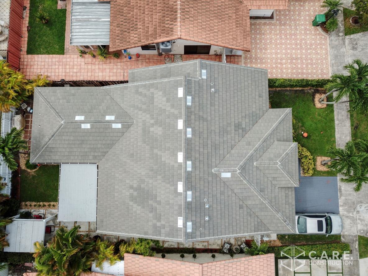 An aerial view of a house with a car parked in front of it.