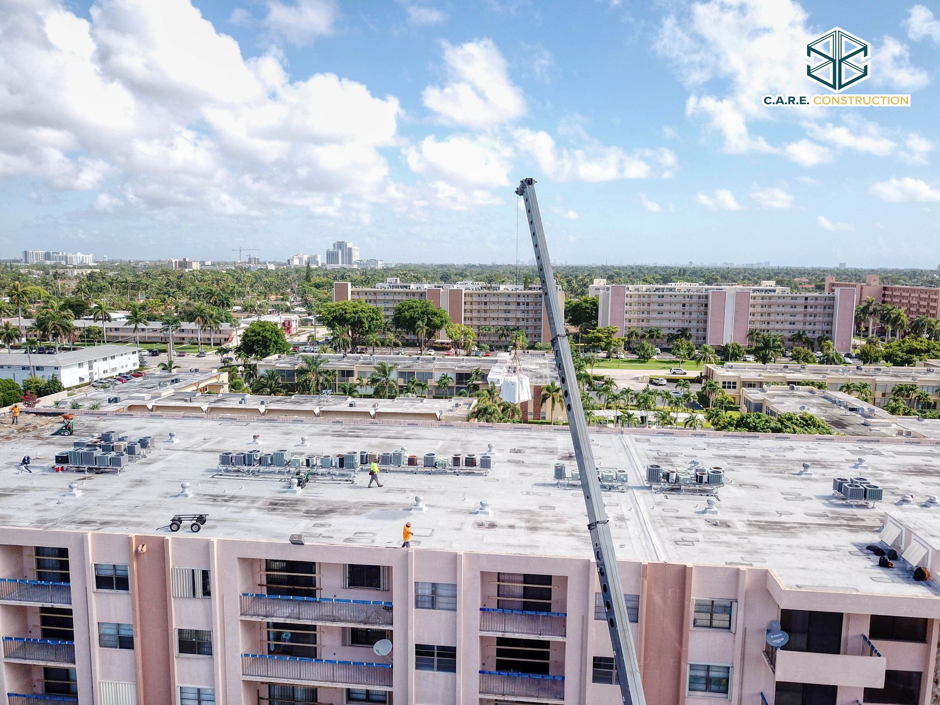 An aerial view of a large building with a crane on top of it.
