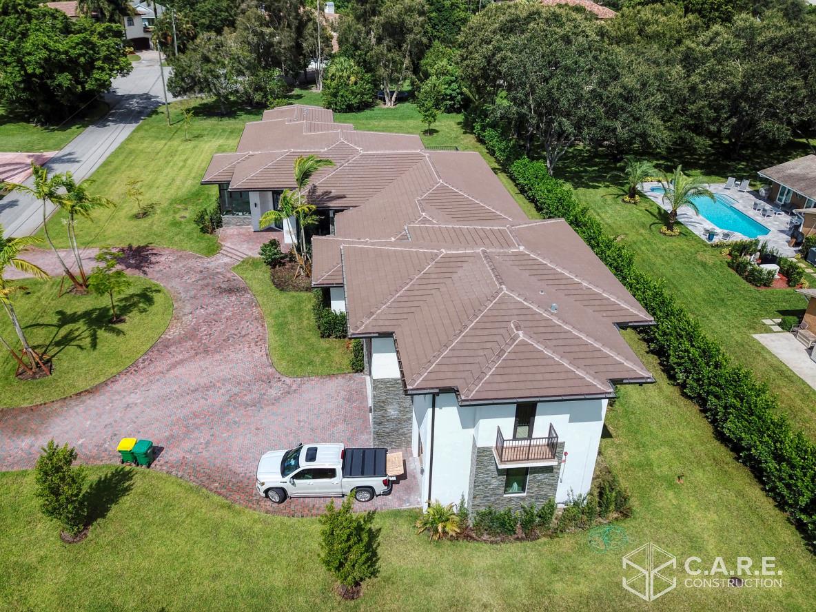 An aerial view of a house with a truck parked in front of it.