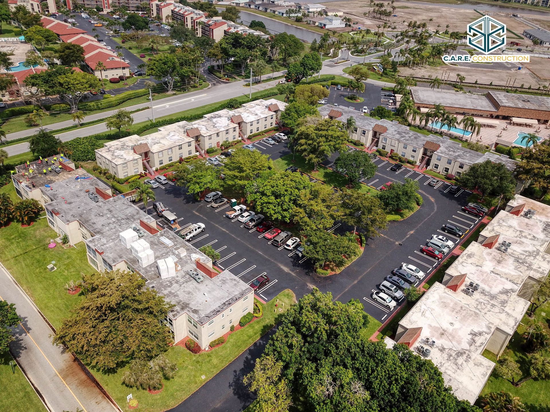 An aerial view of a residential area with lots of trees and buildings.