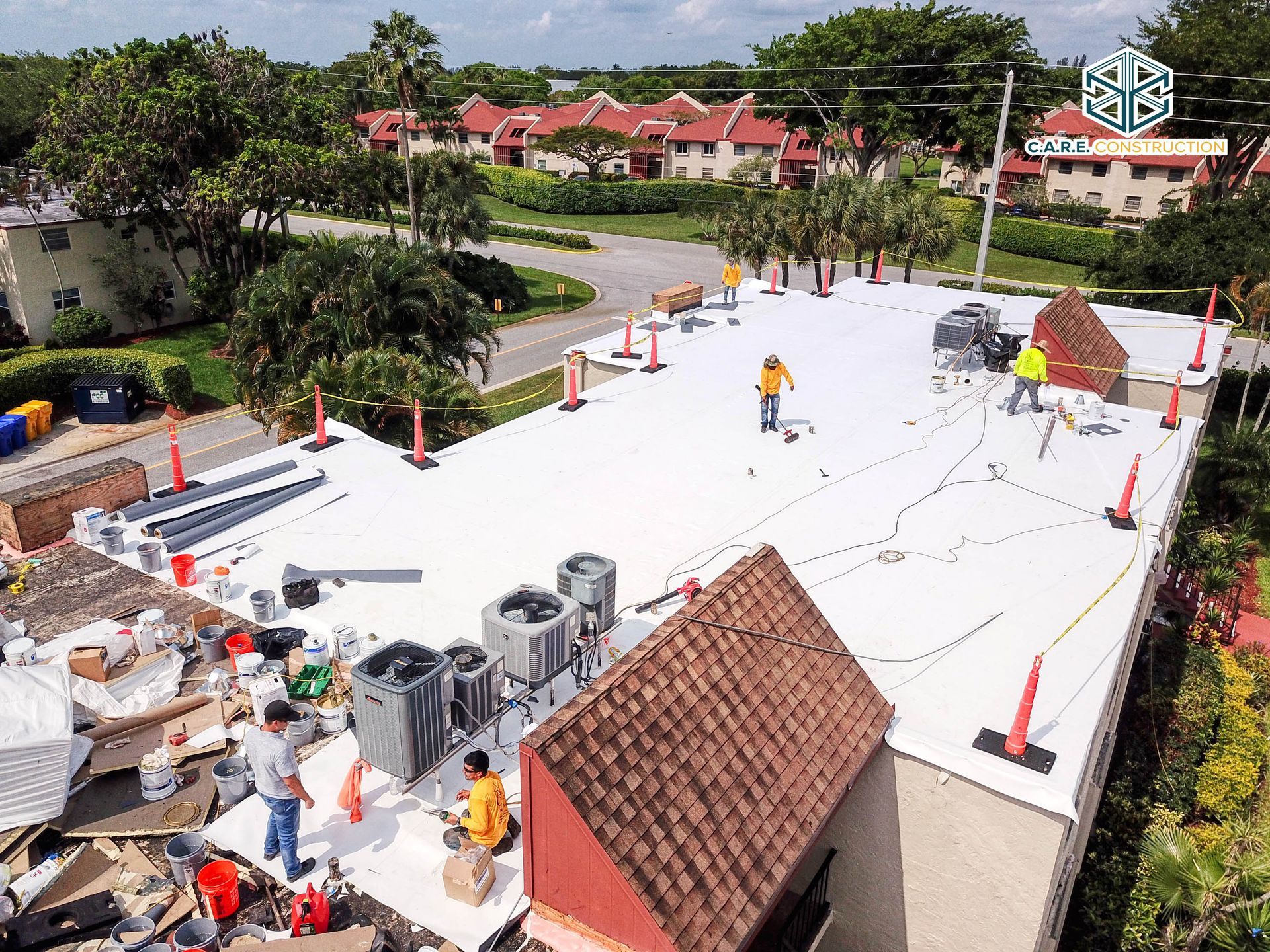 An aerial view of a roof with workers on it