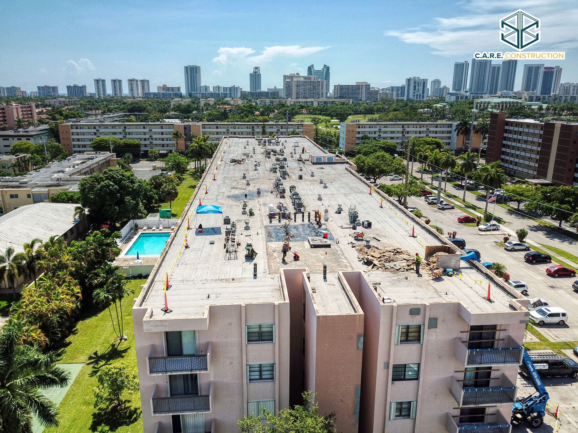 An aerial view of a building with a pool in the middle of it