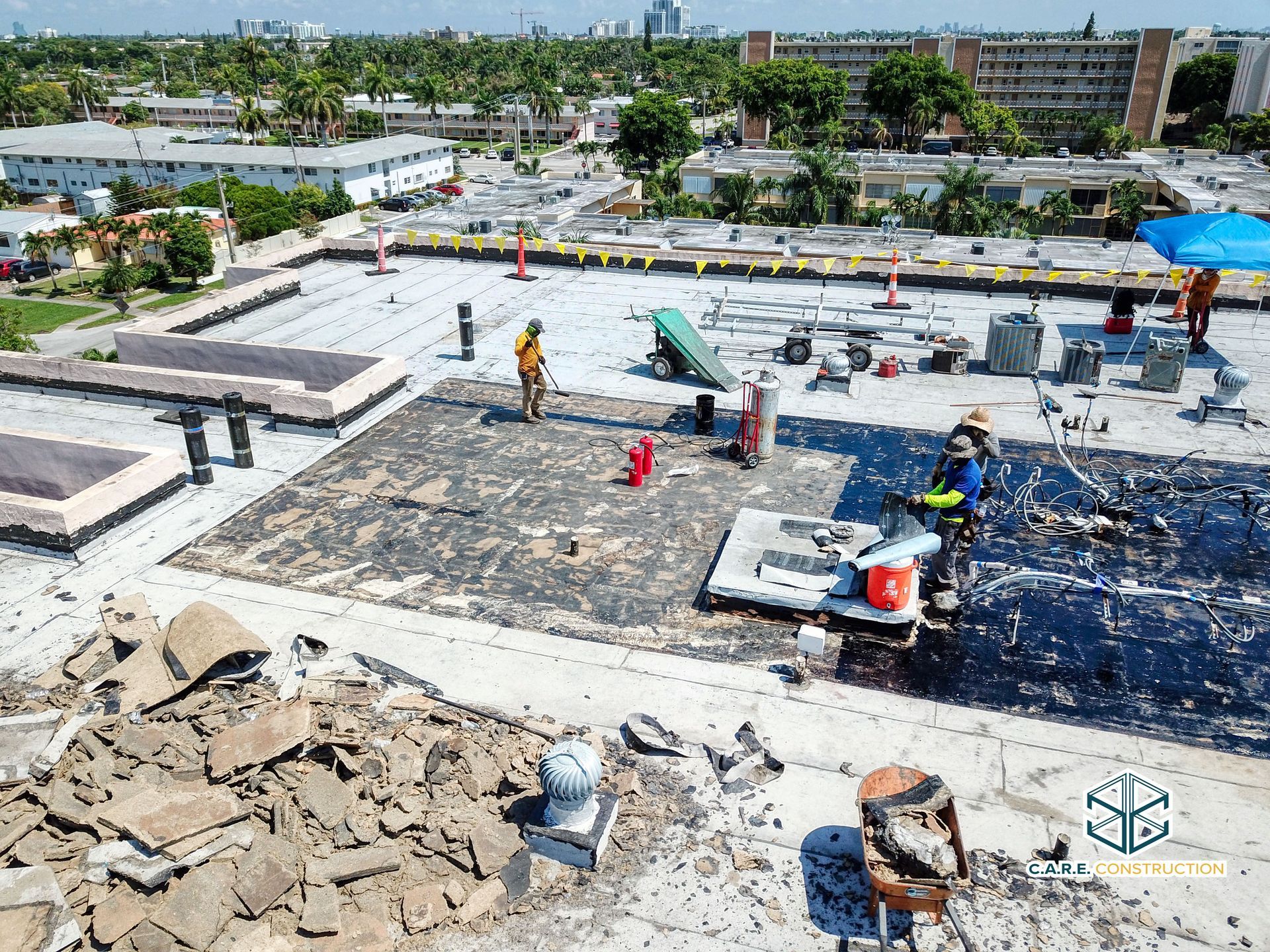 An aerial view of a roof with workers working on it.