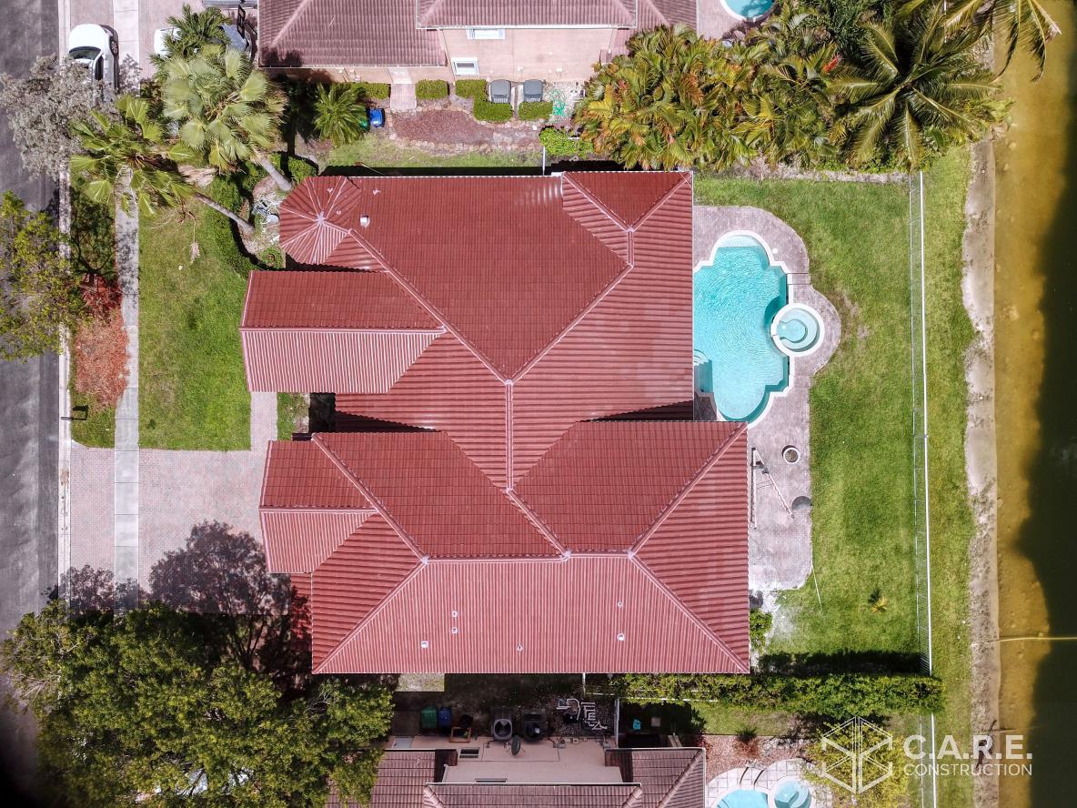 An aerial view of a house with a pool in the backyard.