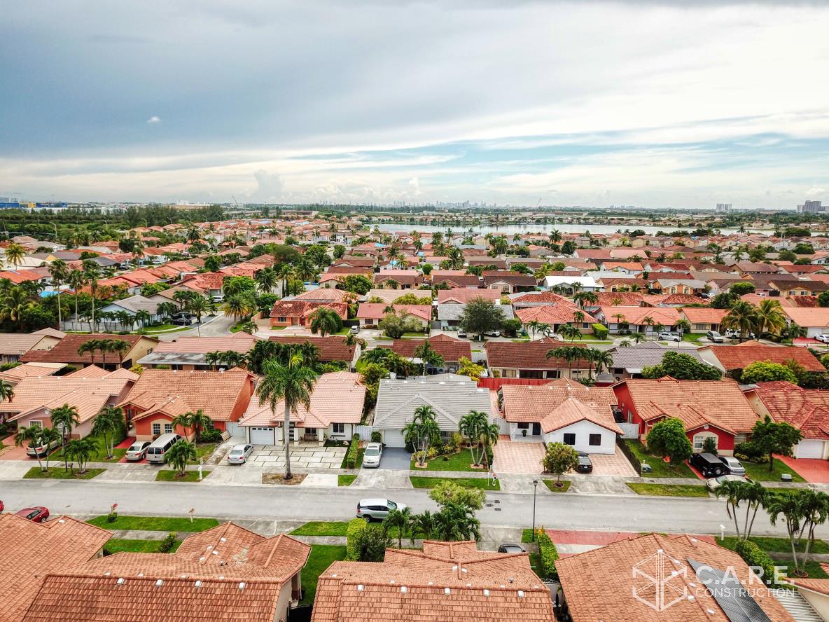 An aerial view of a residential area with lots of houses and trees.