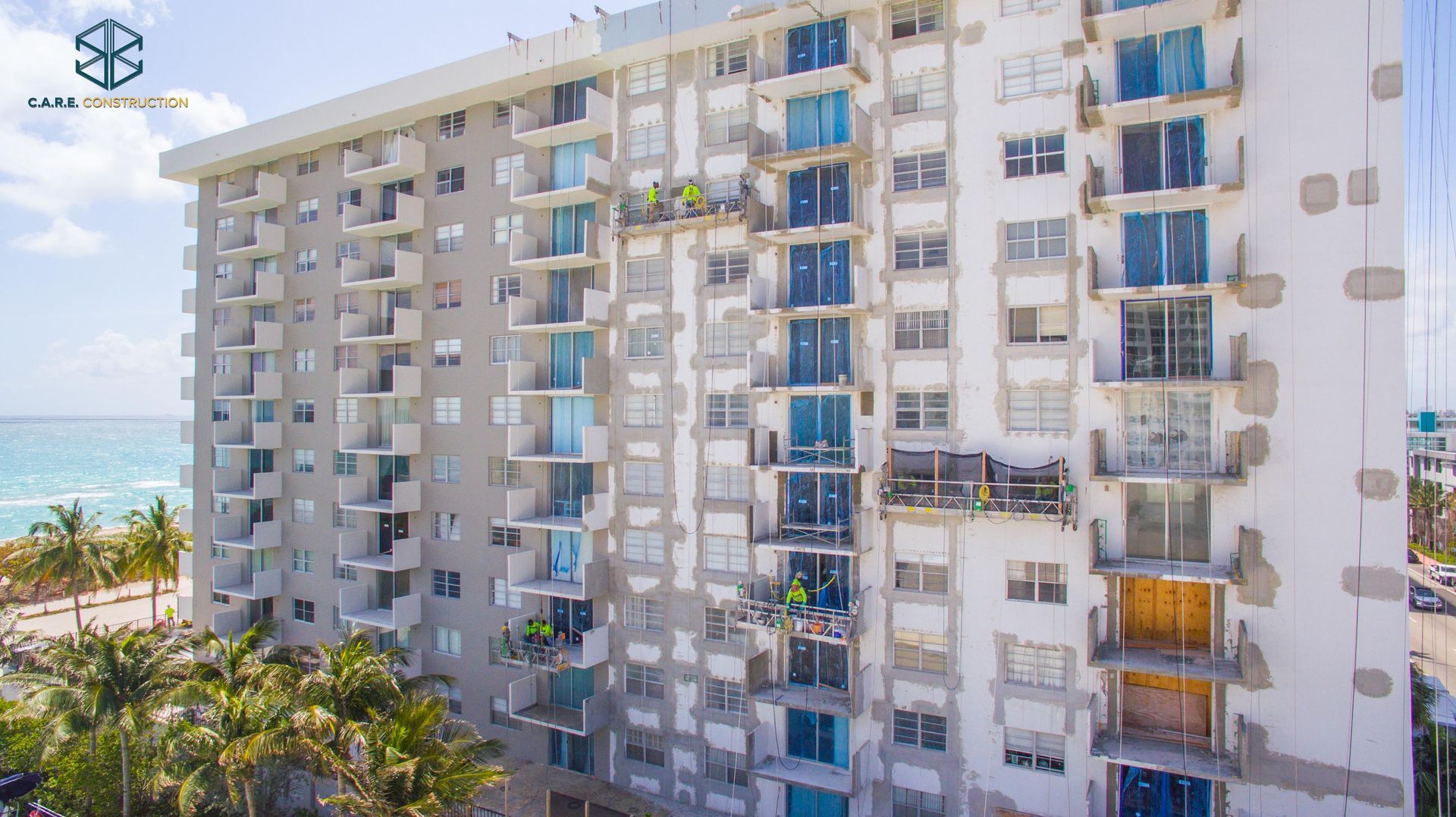 An aerial view of a tall building with a lot of windows.