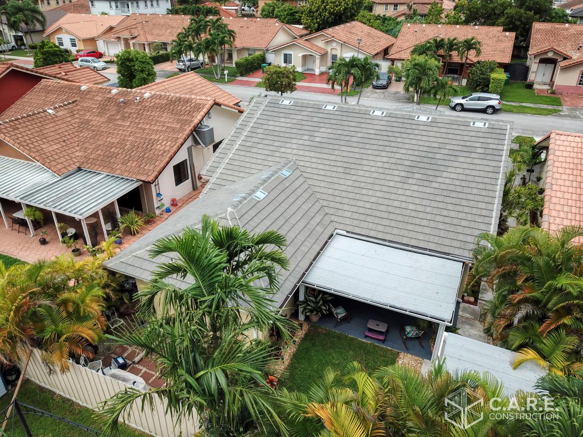 An aerial view of a house with a roof that is covered in shingles.