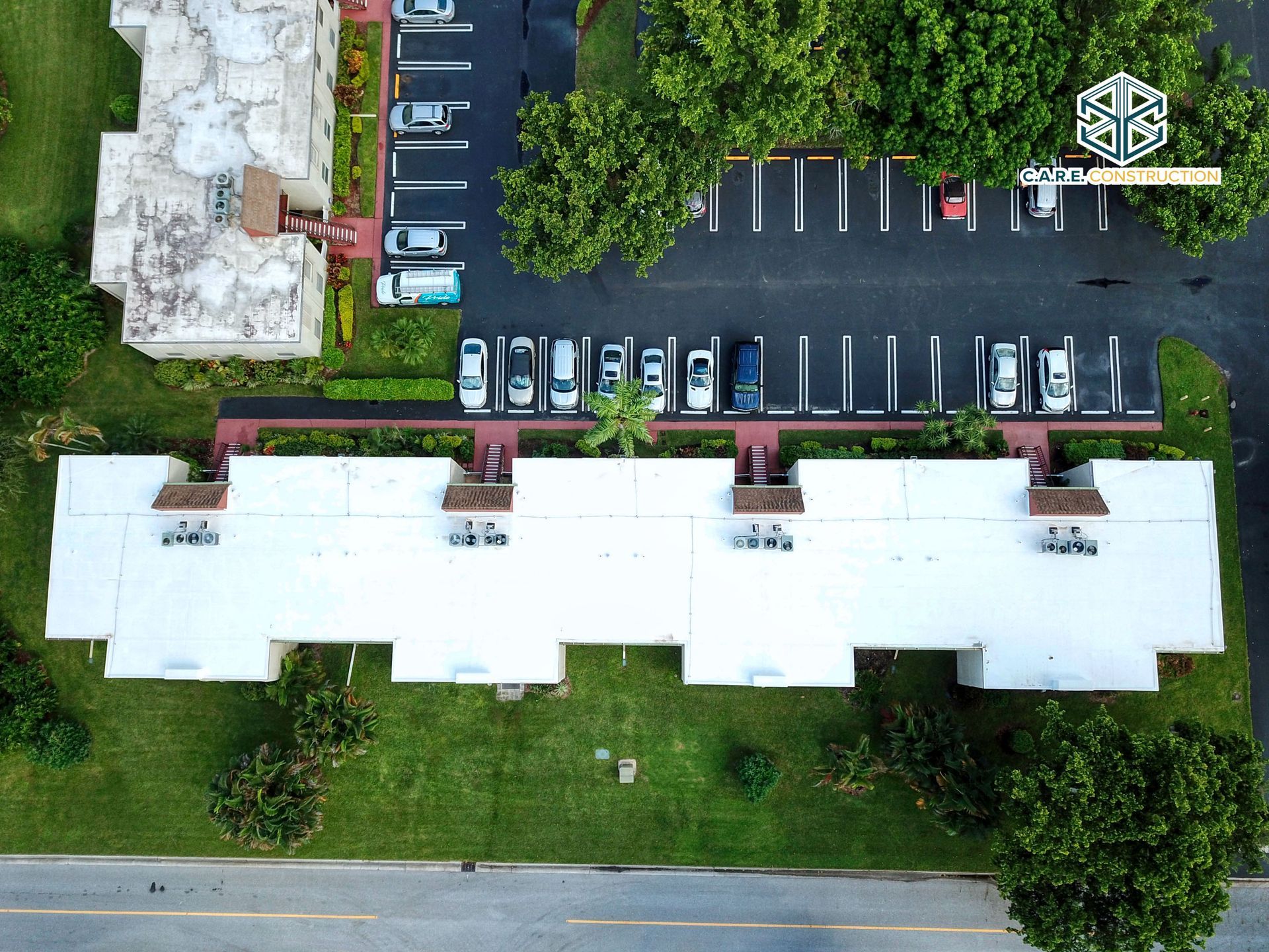 An aerial view of a building with cars parked in front of it