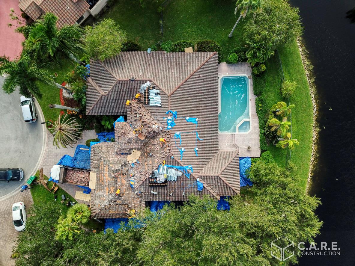 An aerial view of a house with a pool in the backyard.