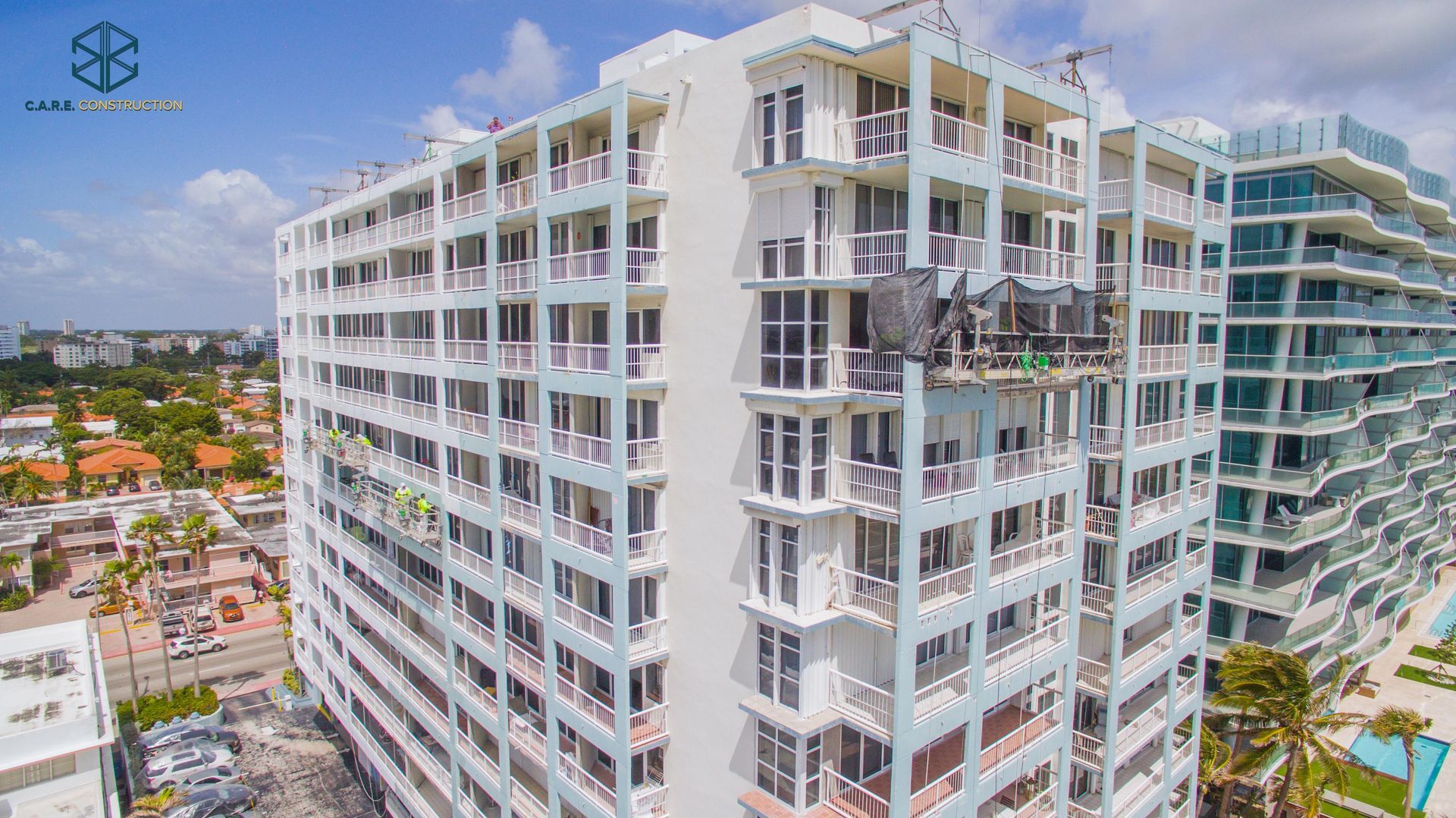 An aerial view of a large building under construction in a city.