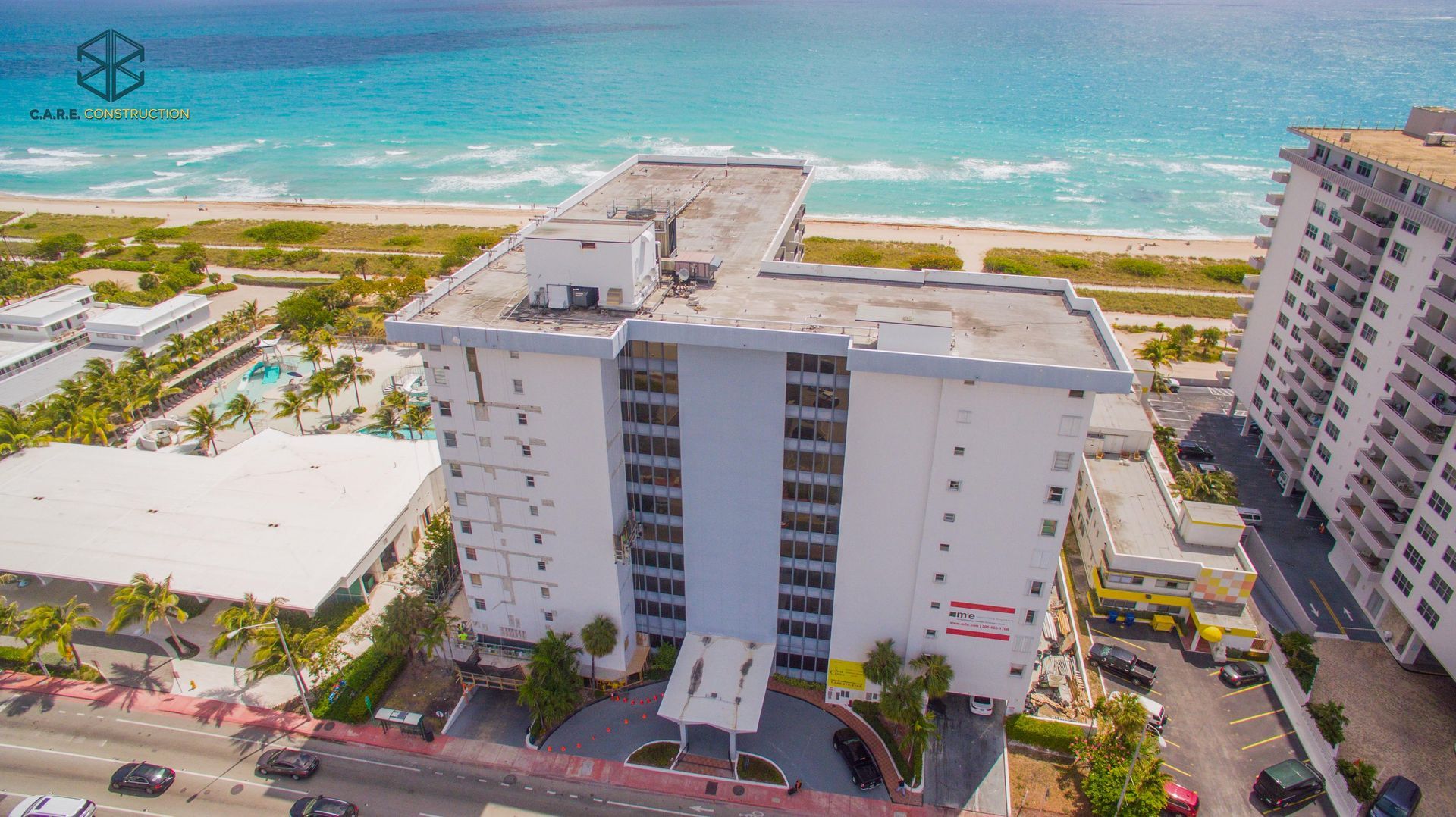 An aerial view of a building next to the ocean