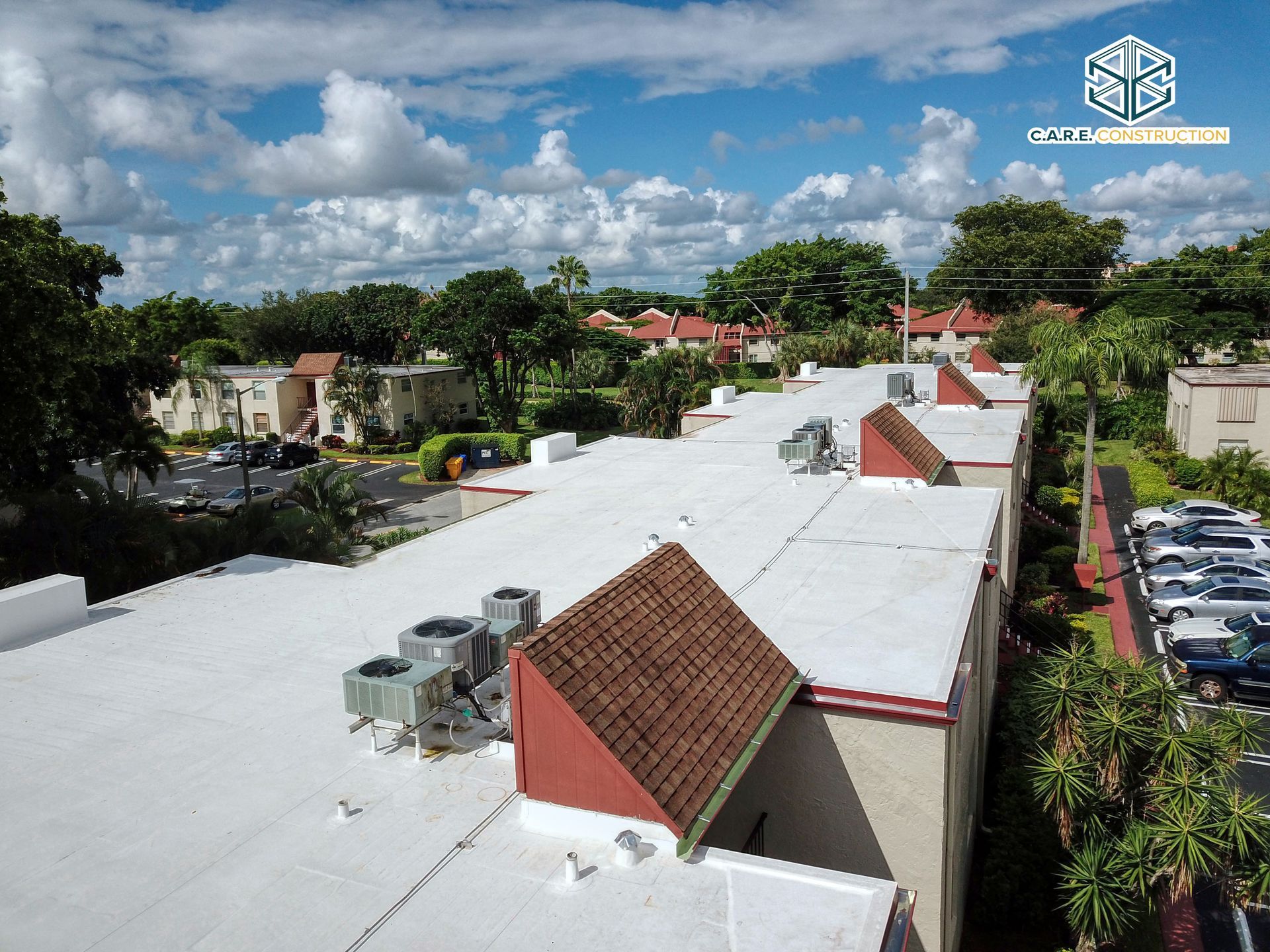 An aerial view of a building with a white roof