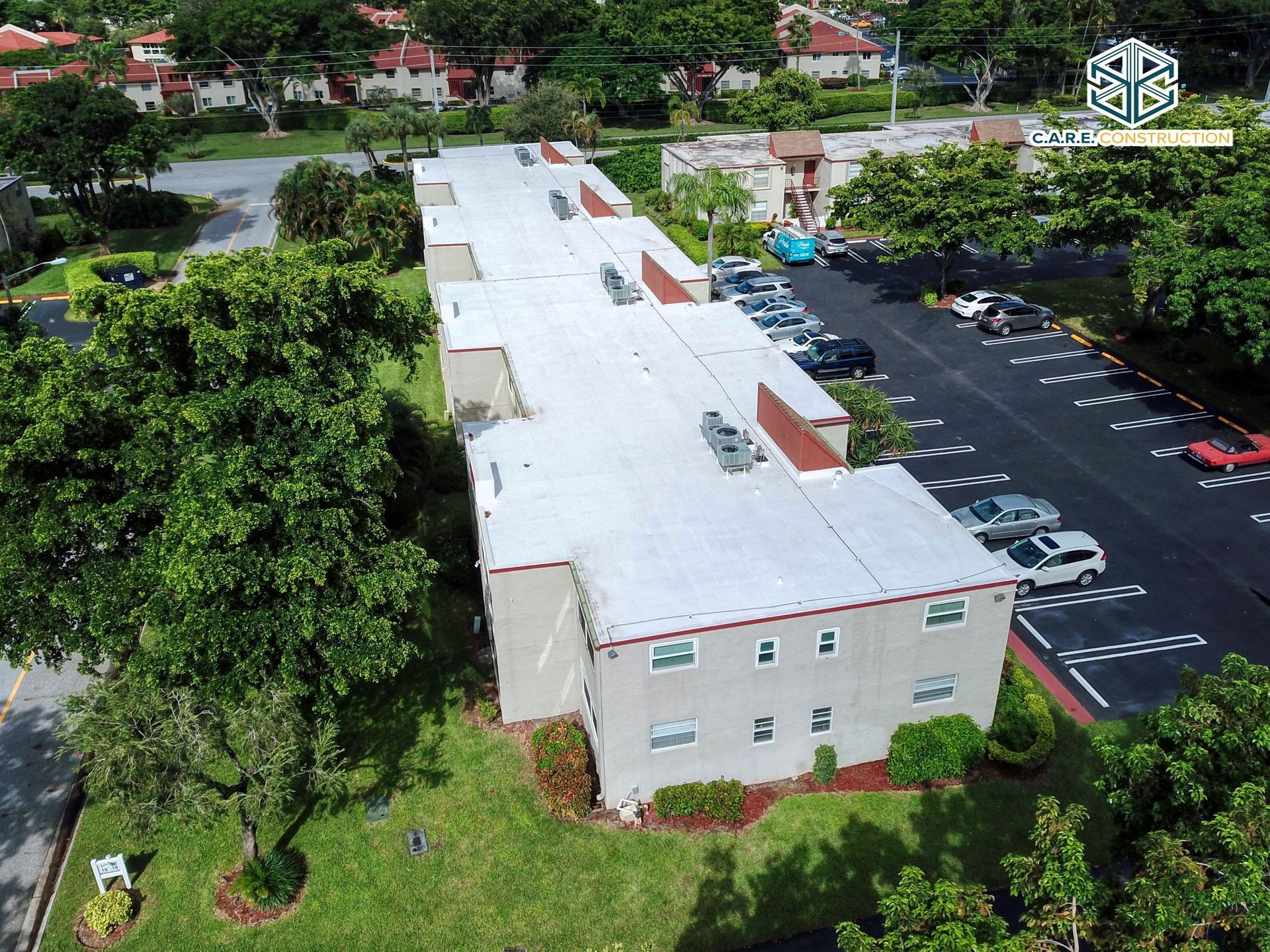 An aerial view of a building with a white roof