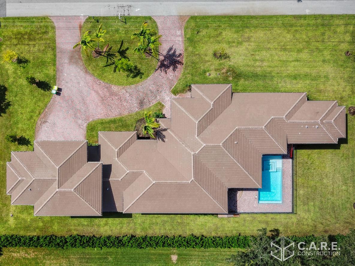 An aerial view of a house with a pool in the backyard.
