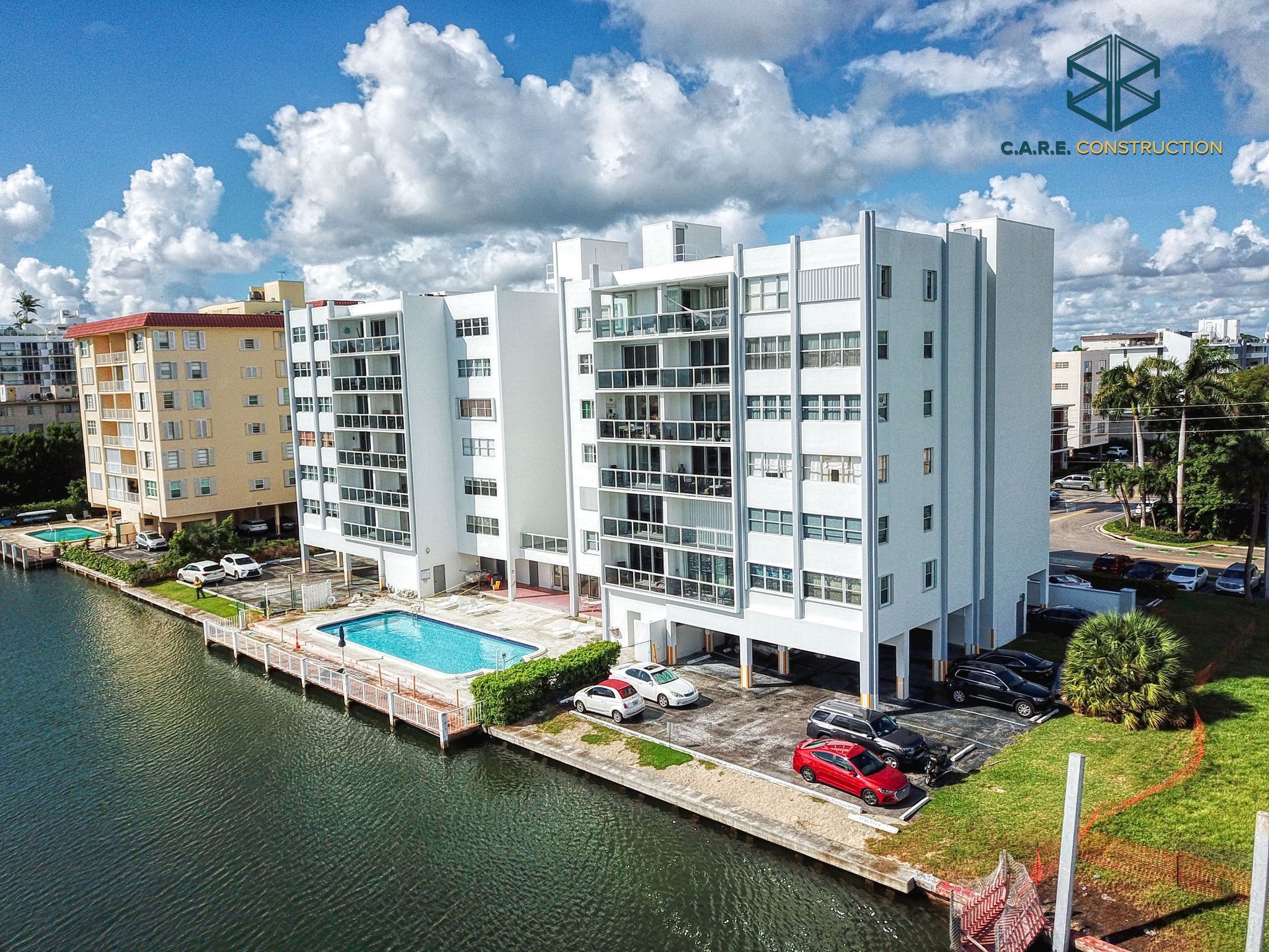 An aerial view of a building next to a body of water