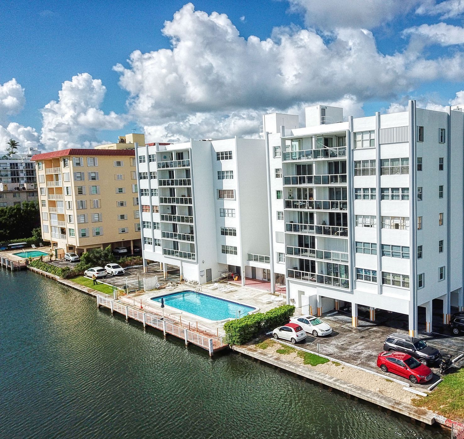 An aerial view of a building next to a body of water