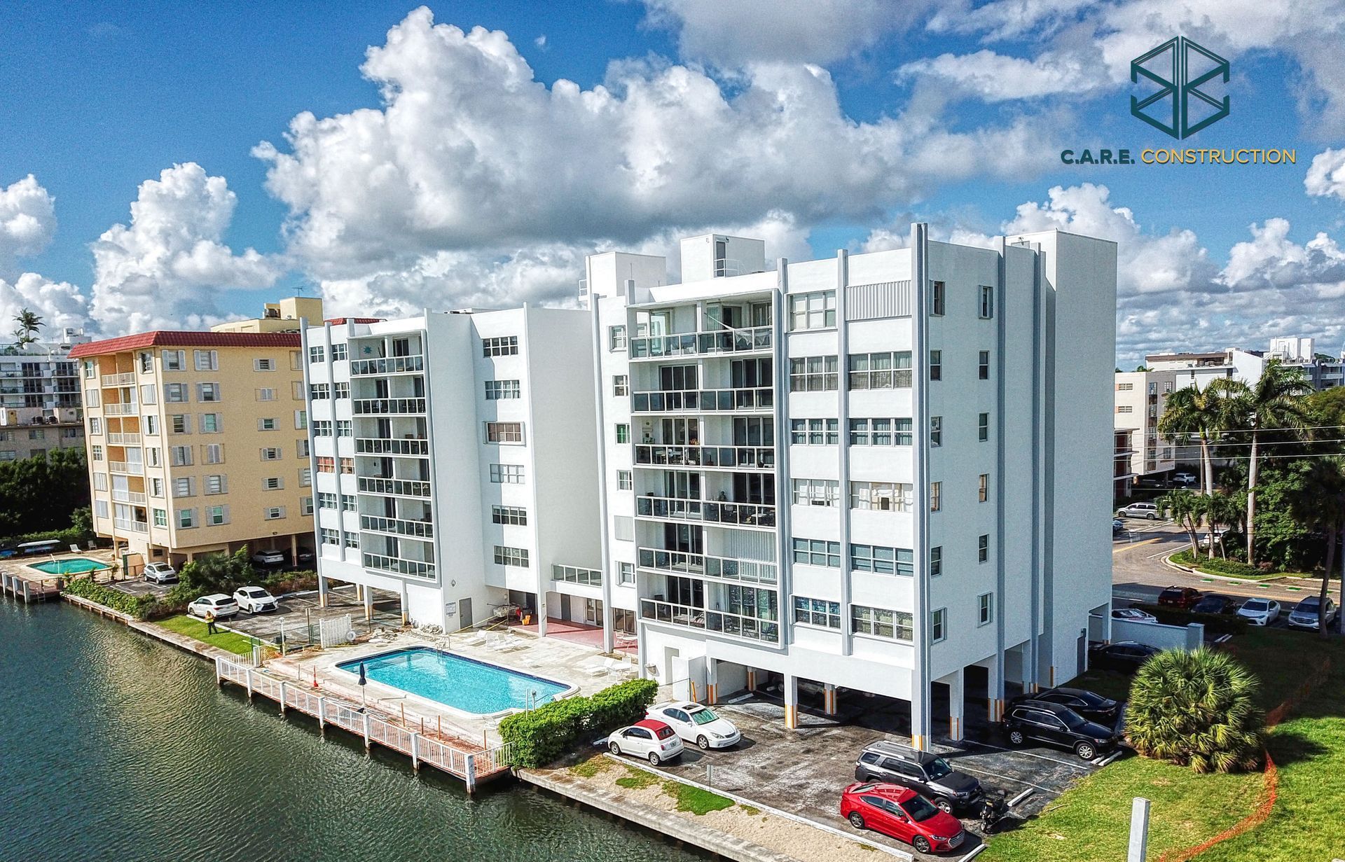 An aerial view of a building next to a body of water