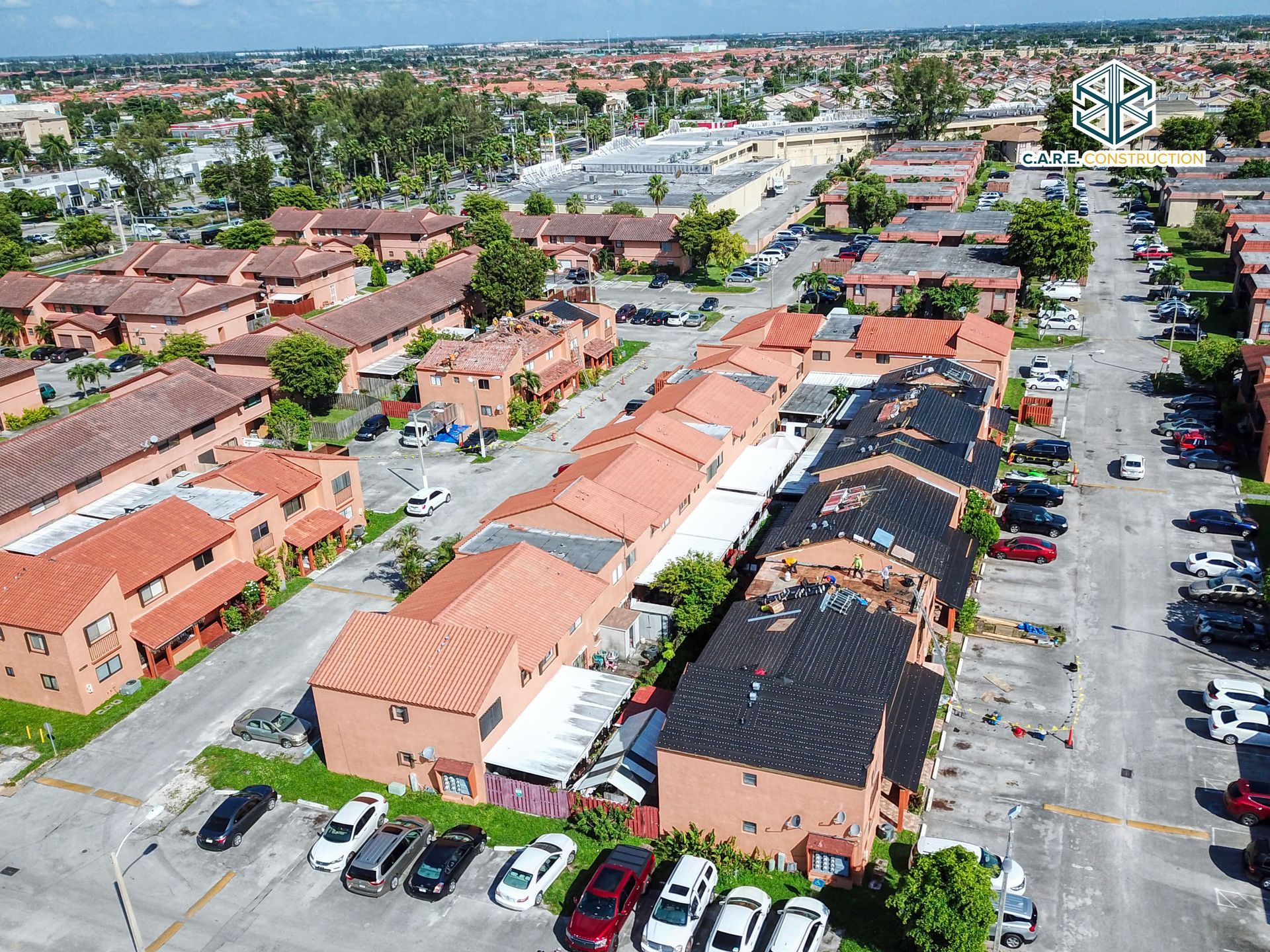 An aerial view of a residential area with lots of houses and cars parked in front of them.