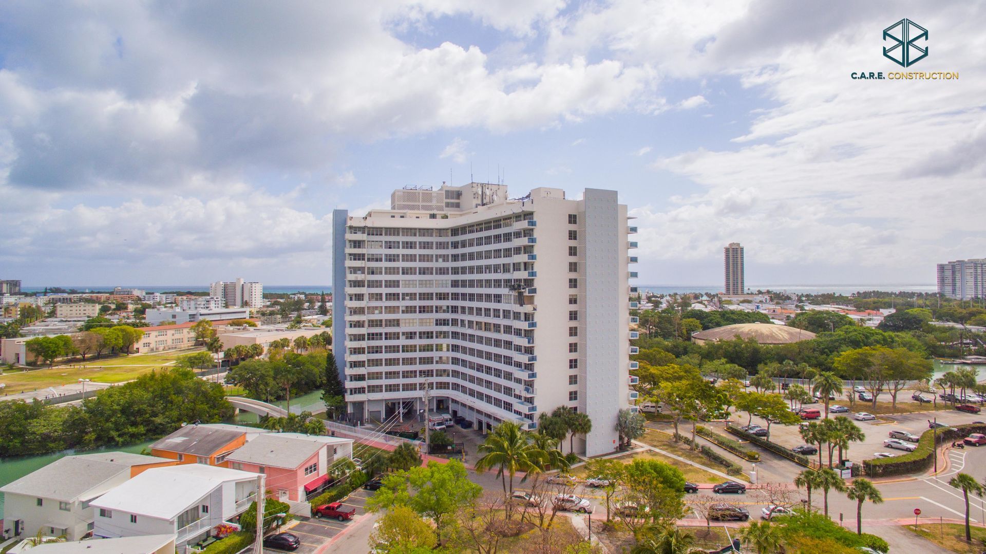 An aerial view of a large white building in a city