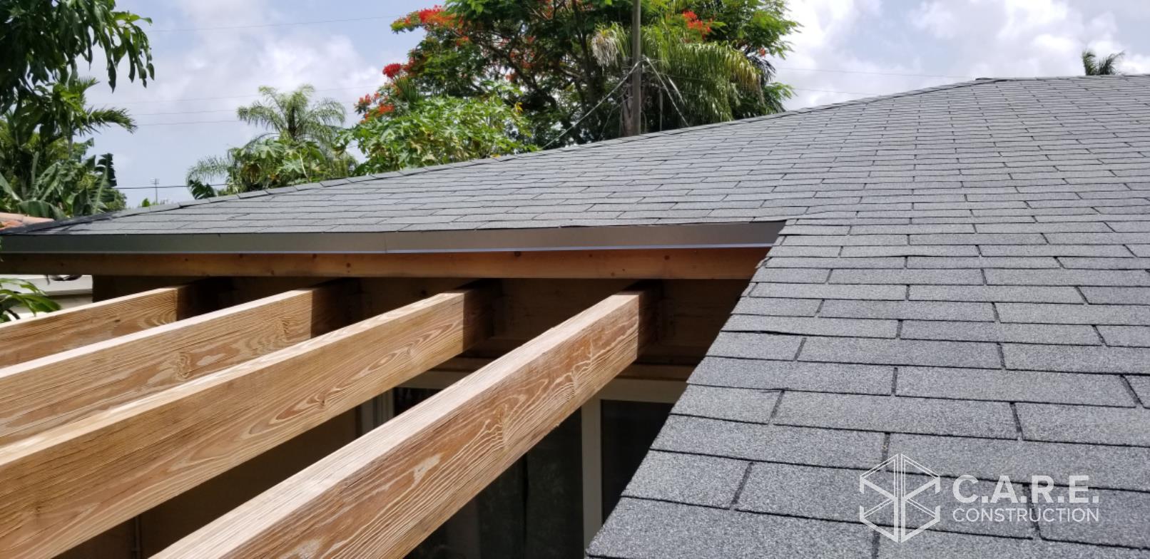 A close up of a roof with a pergola underneath it