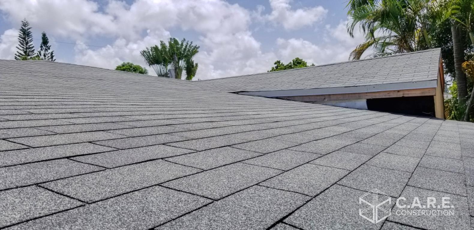 A close up of a roof with a blue sky in the background.