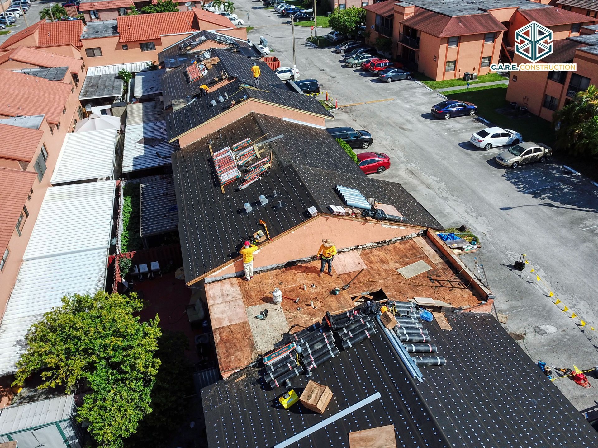 A group of people are working on the roof of a building.