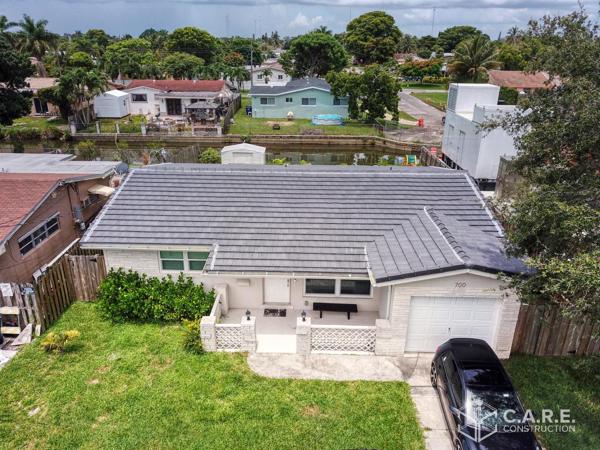 An aerial view of a house with a car parked in front of it.
