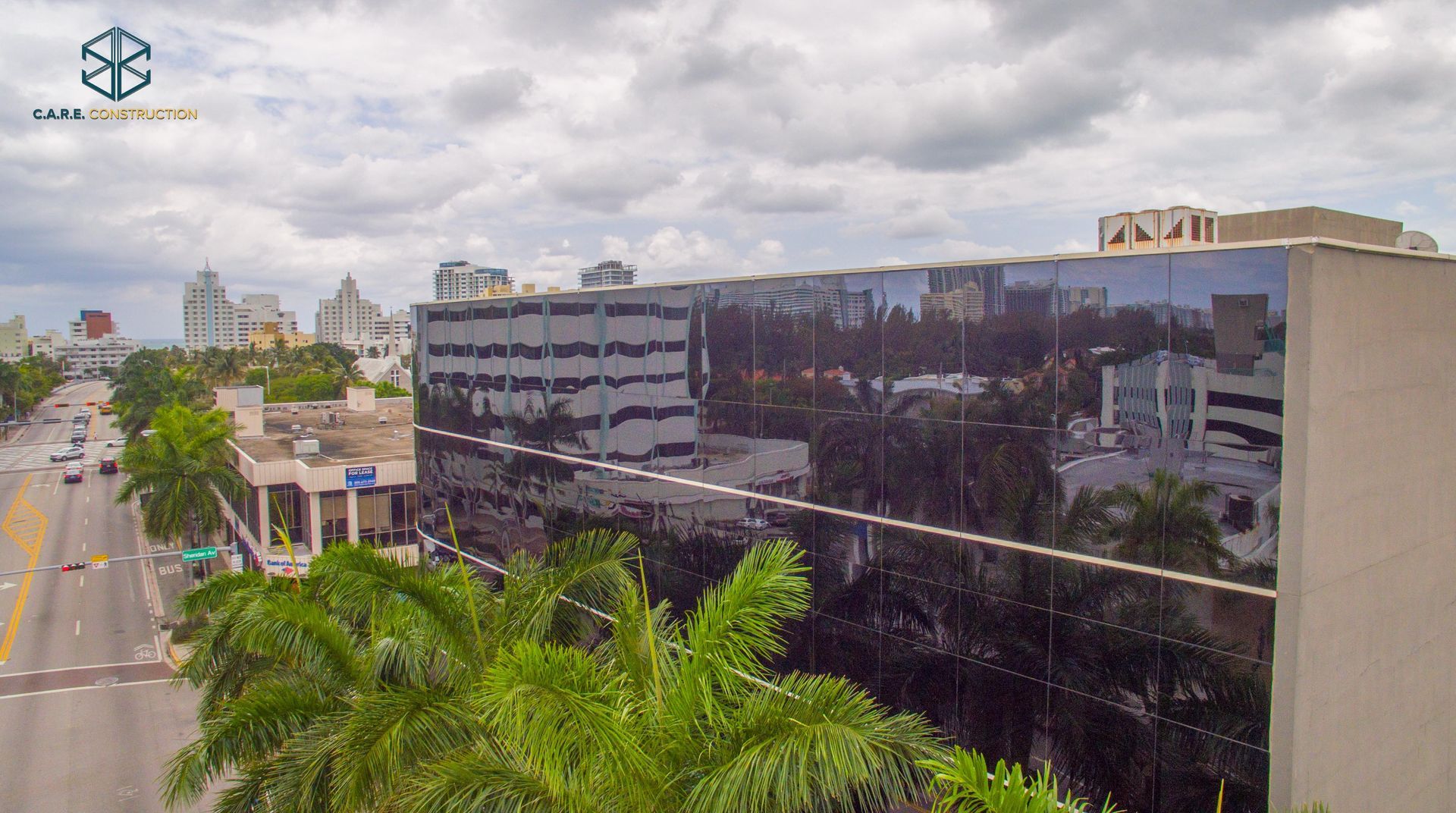 An aerial view of a city with a large building in the foreground