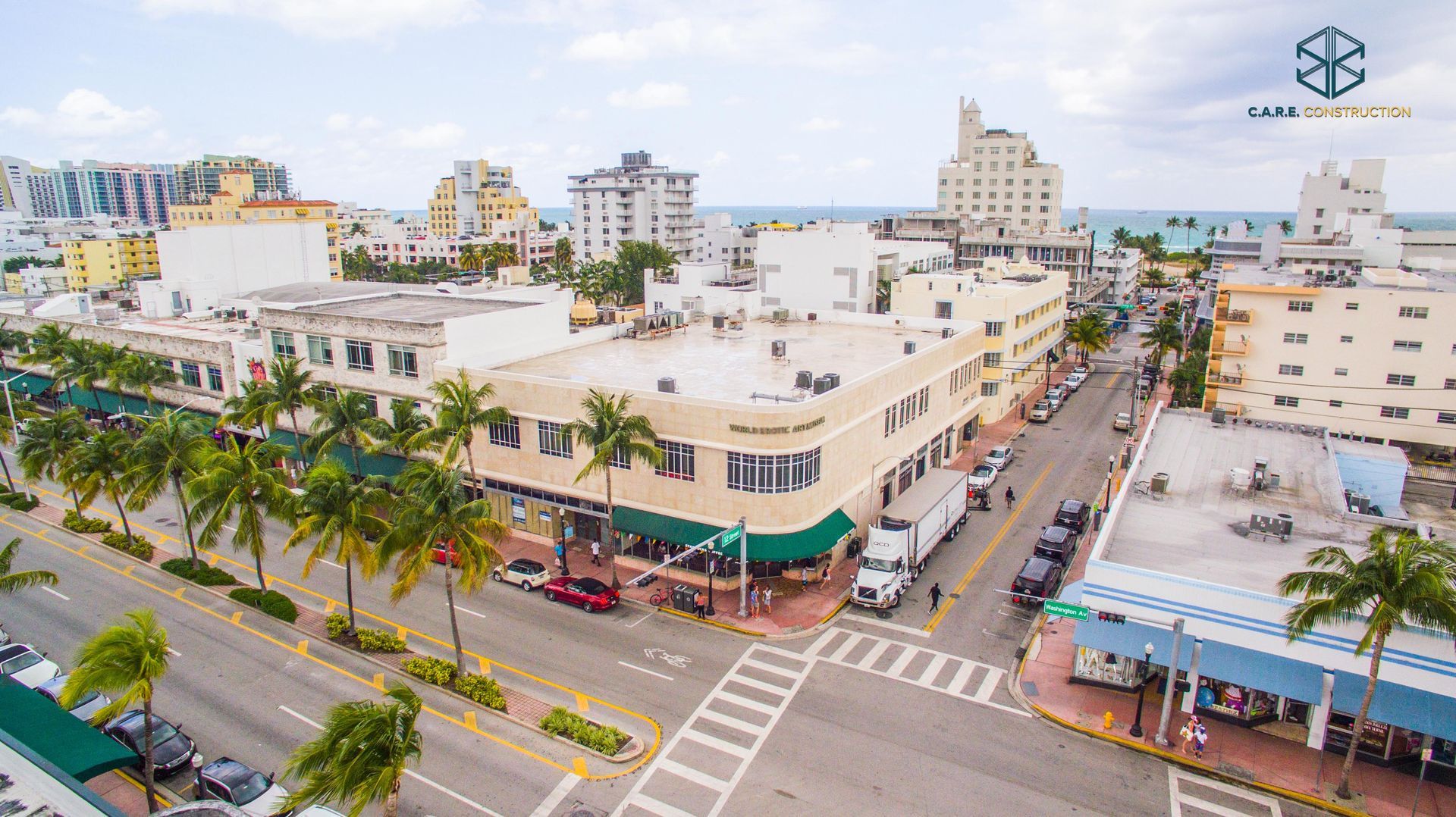 An aerial view of a city street with lots of buildings and palm trees.
