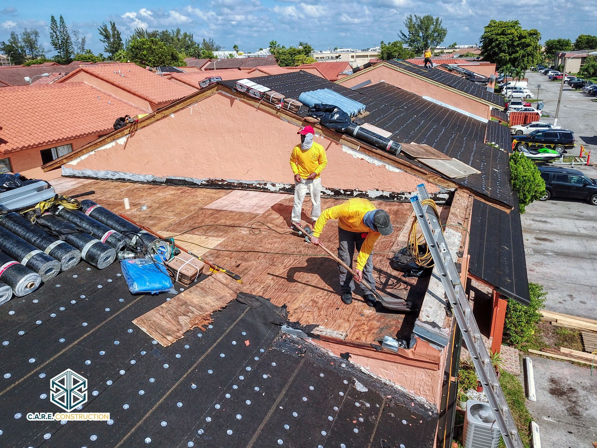 A group of men are working on the roof of a building.