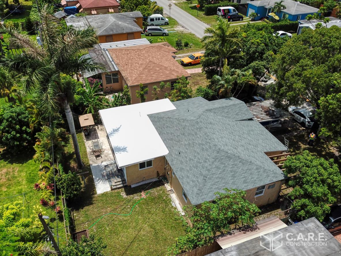 An aerial view of a house with a green roof