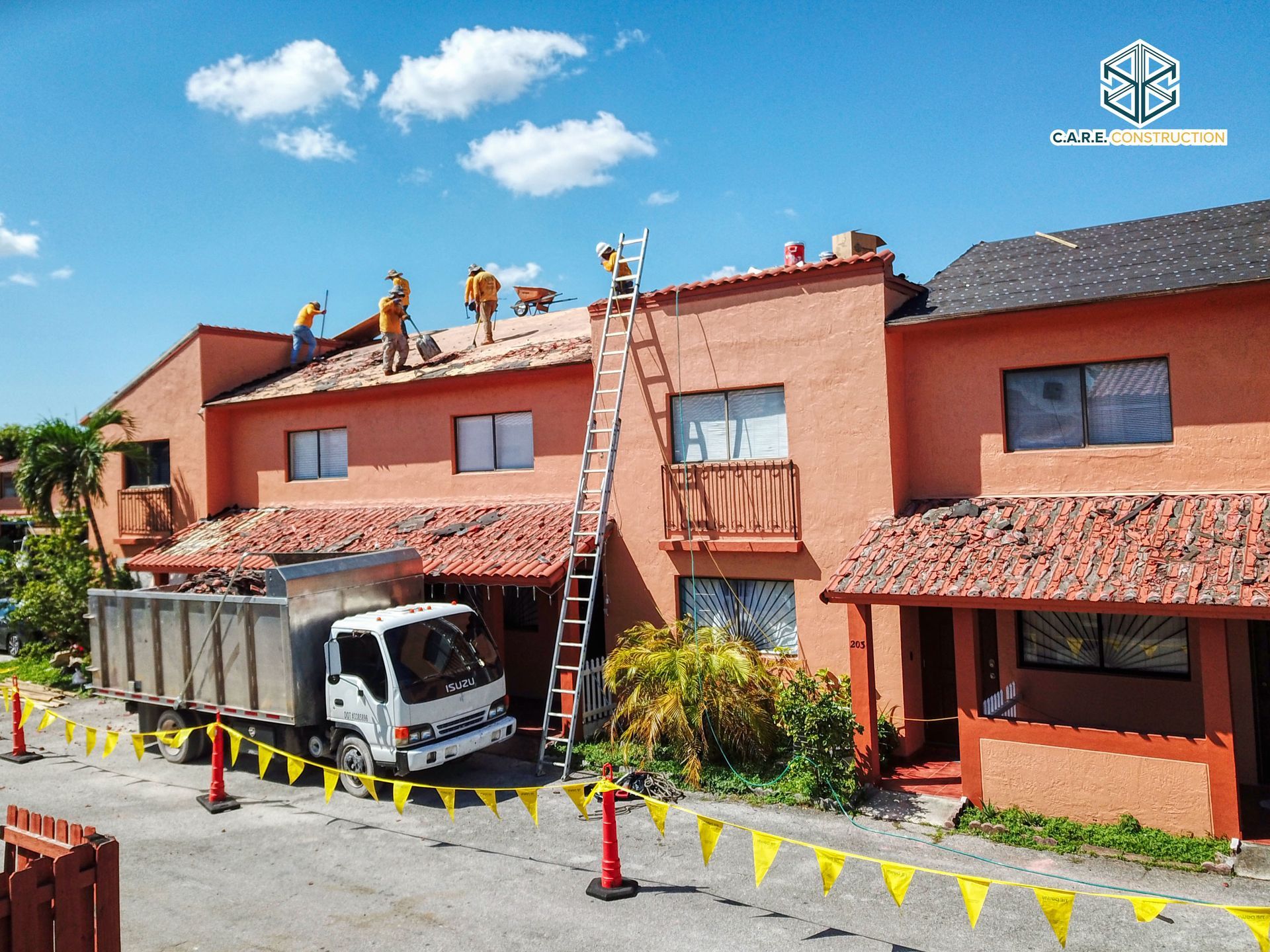 A white truck is parked in front of an orange building