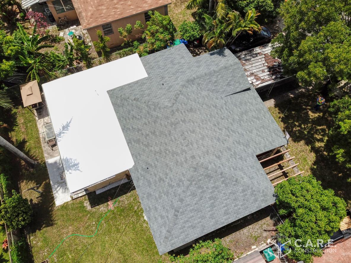 An aerial view of a house with a roof that is being installed.