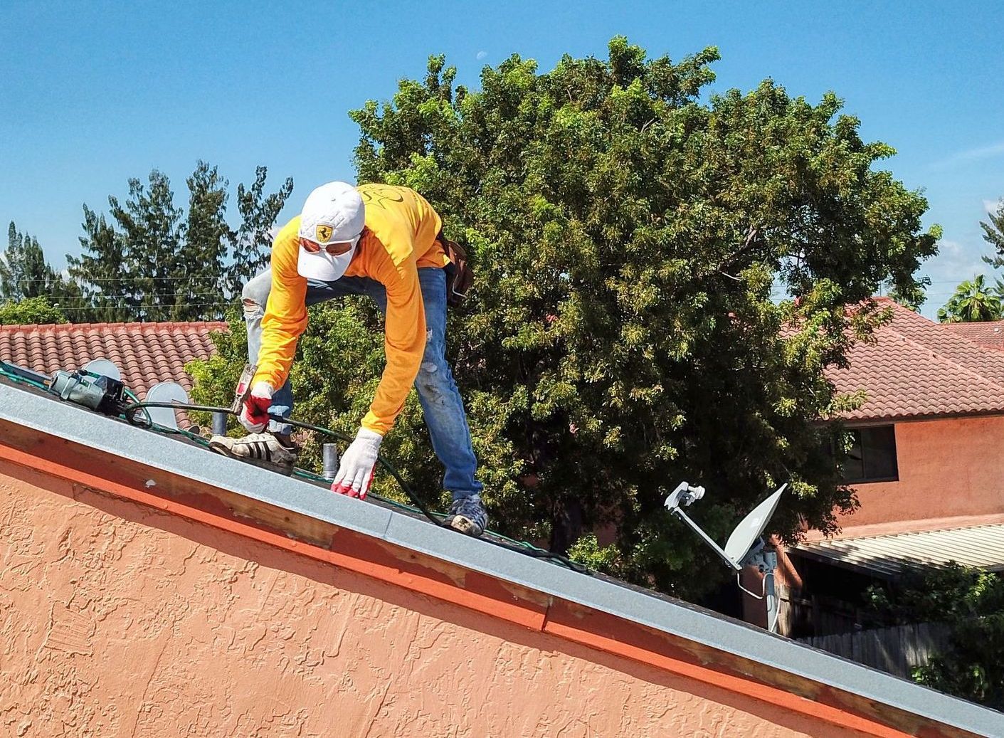 A man is working on the roof of a house