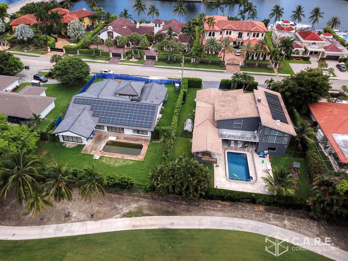 An aerial view of a house with solar panels on the roof