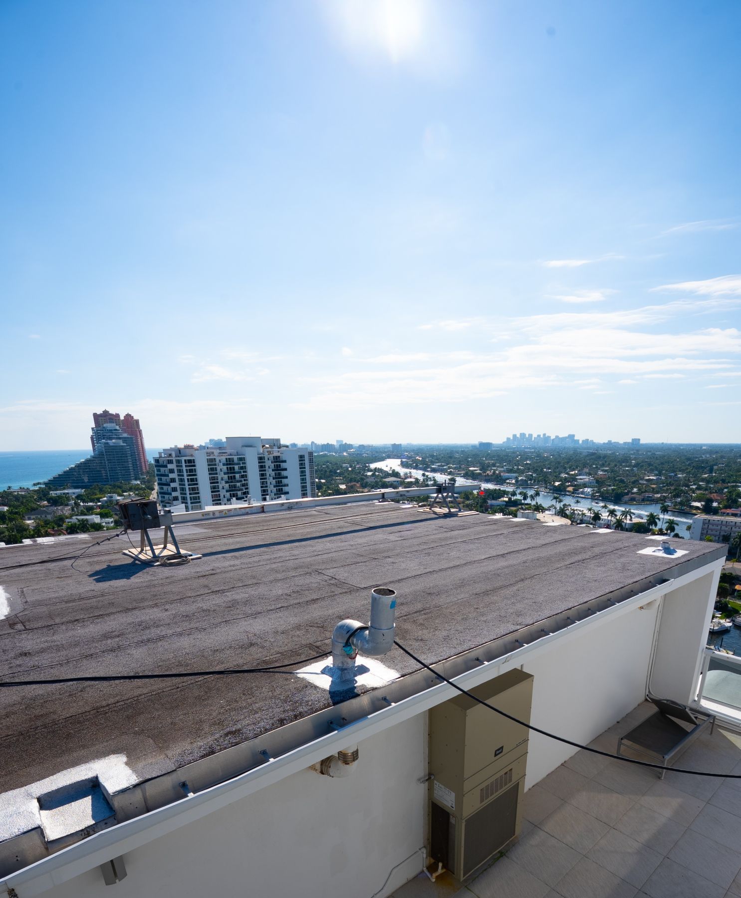 An aerial view of a roof with workers working on it.