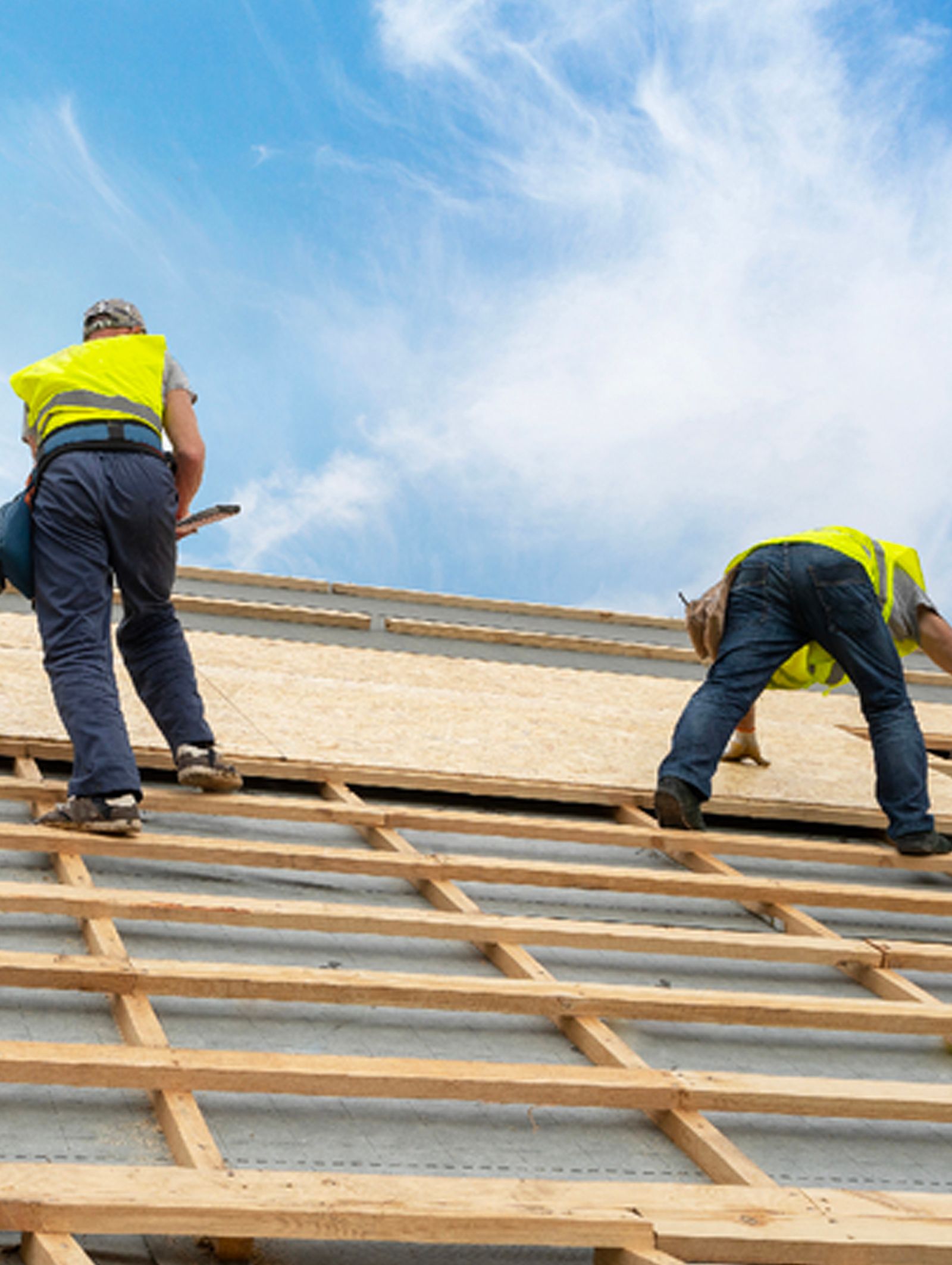 A group of people are working on the roof of a building.