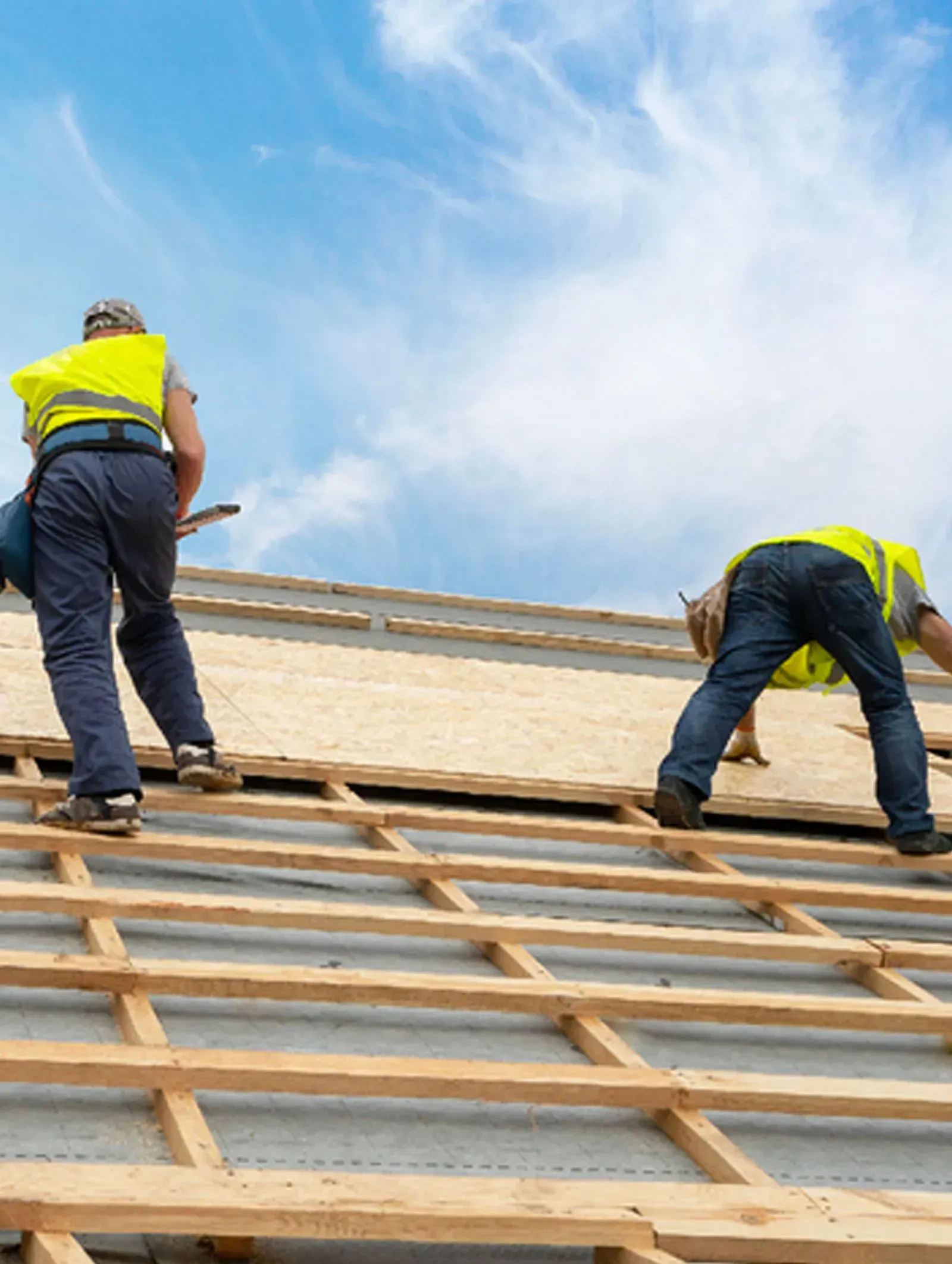 A group of people are working on the roof of a building.