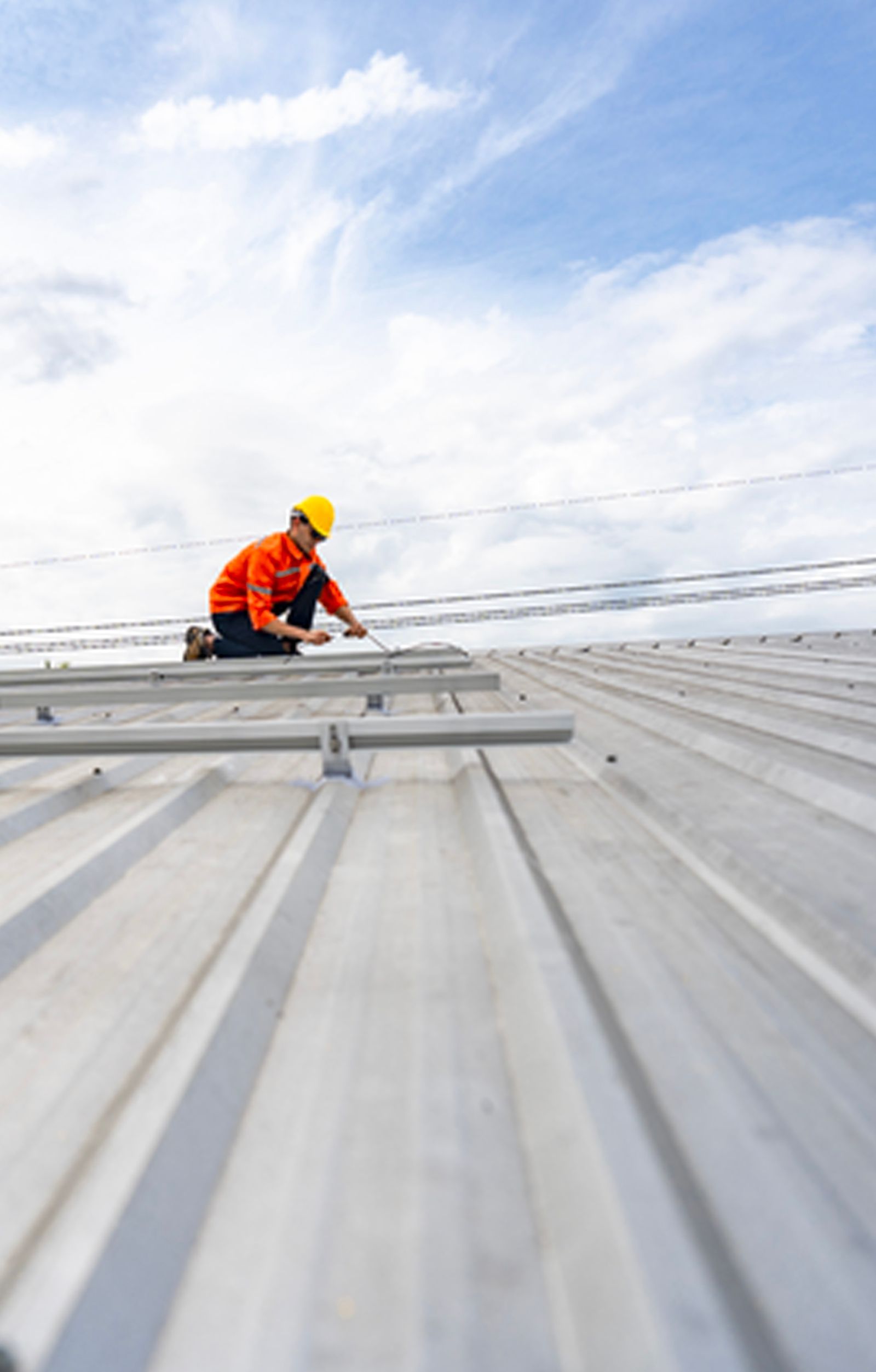 A group of people are working on the roof of a building.