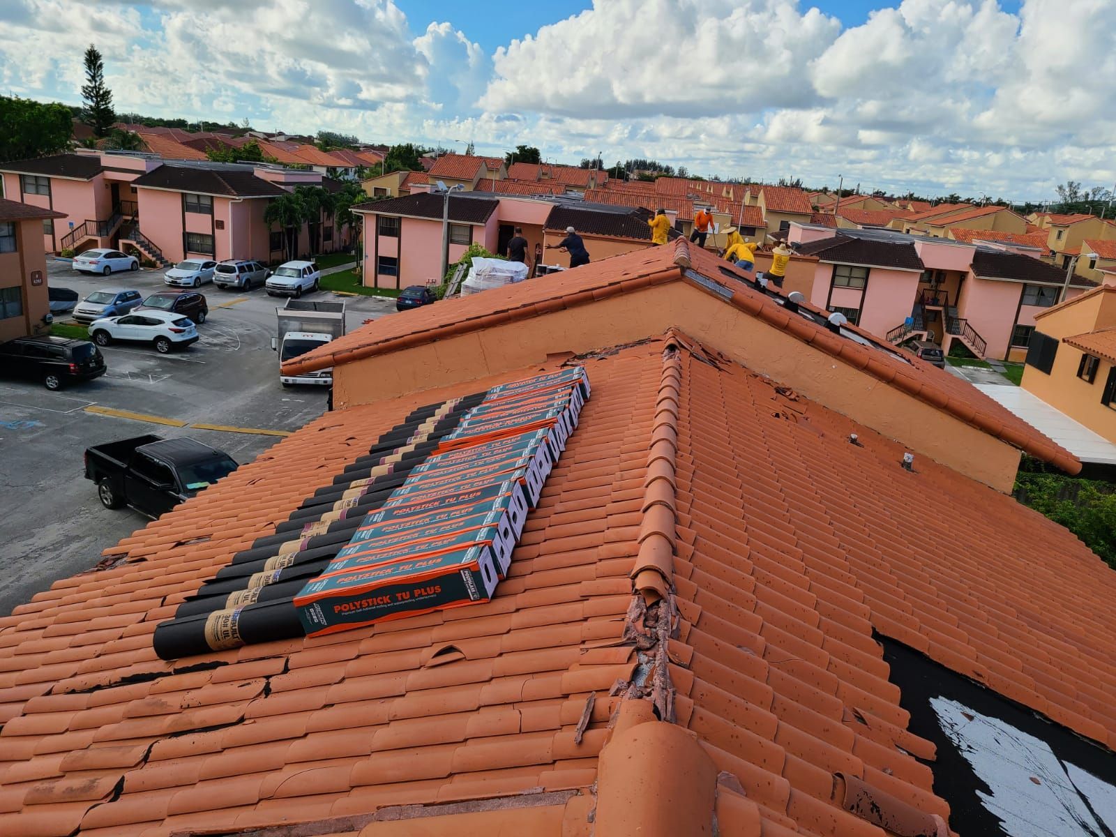 A mattress is sitting on top of a tiled roof.