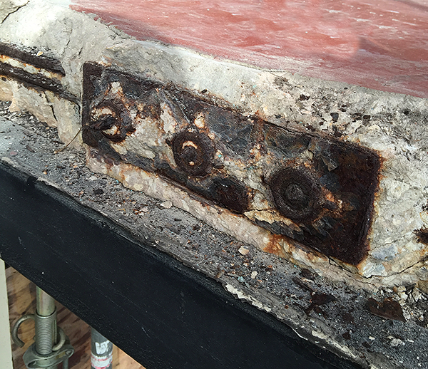 A close up of a rusty piece of metal on a roof.