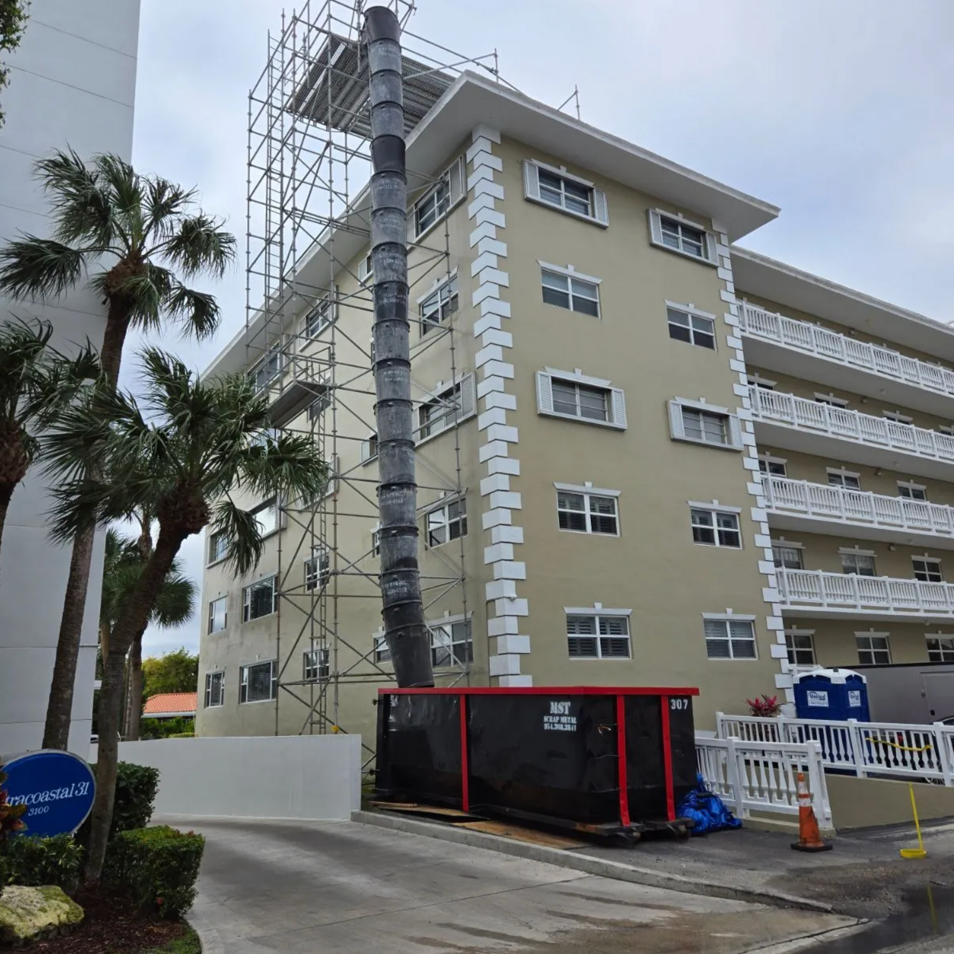 A large building with a dumpster in front of it